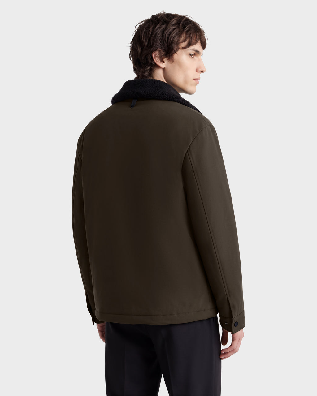 Back view of the Rudsak ANTOINE - 6126506 Olive jacket featuring an olive green shell and a black shearling collar.