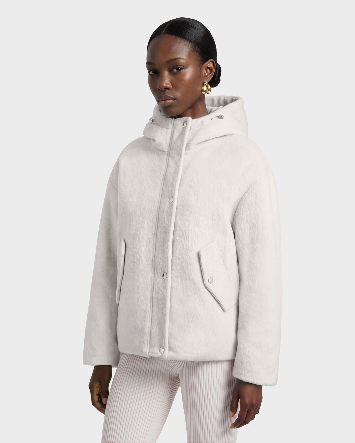 A model wearing a cream-colored Rudsak HAZEL - 8126981 Vanilla wool-blend winter coat featuring a hooded design, snap-button closures, and two front flap pockets.