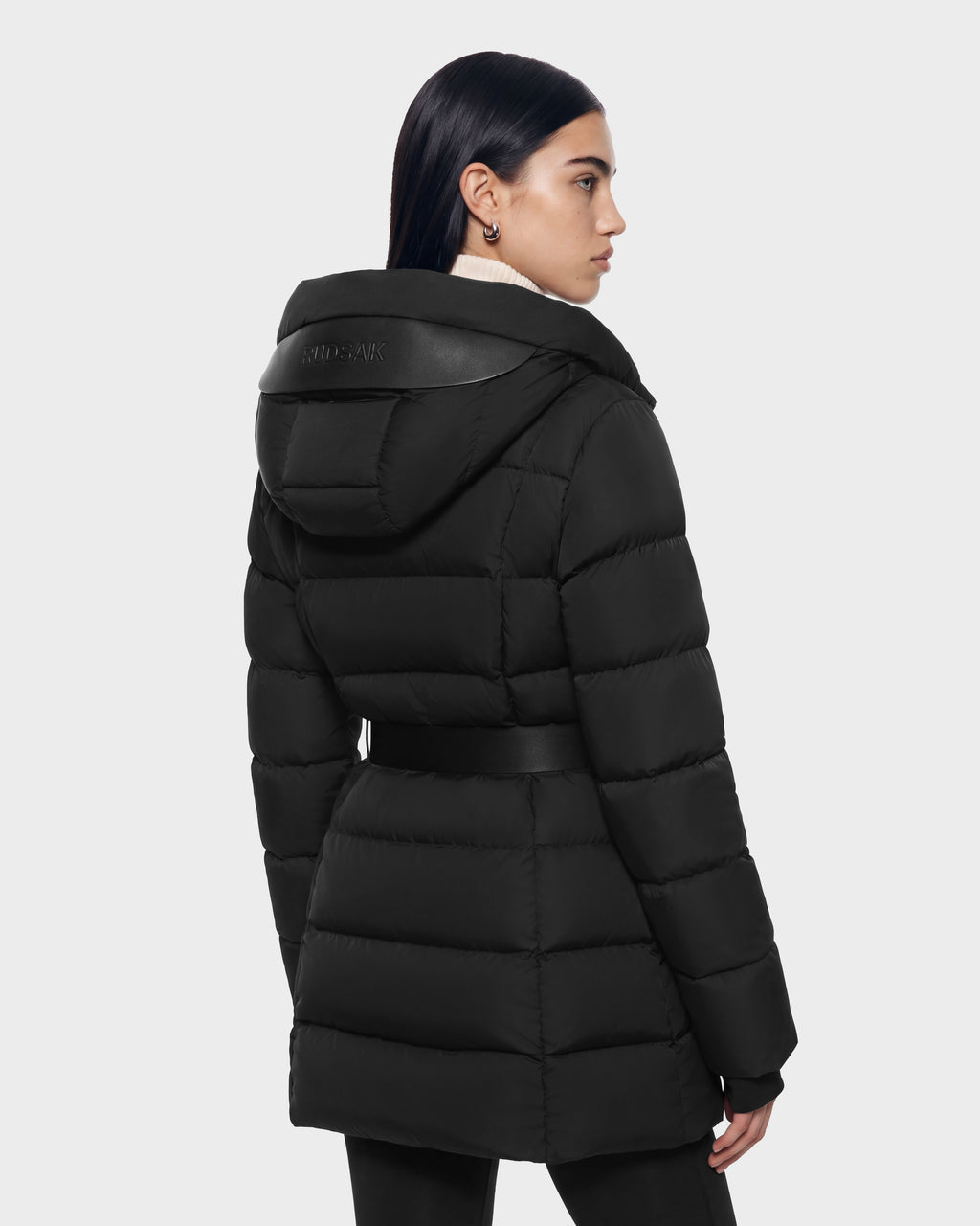 A Rudsak TAYLOR M - 8125965 Black puffer coat featuring a belted waist and a hooded back with leather-trimmed detail.