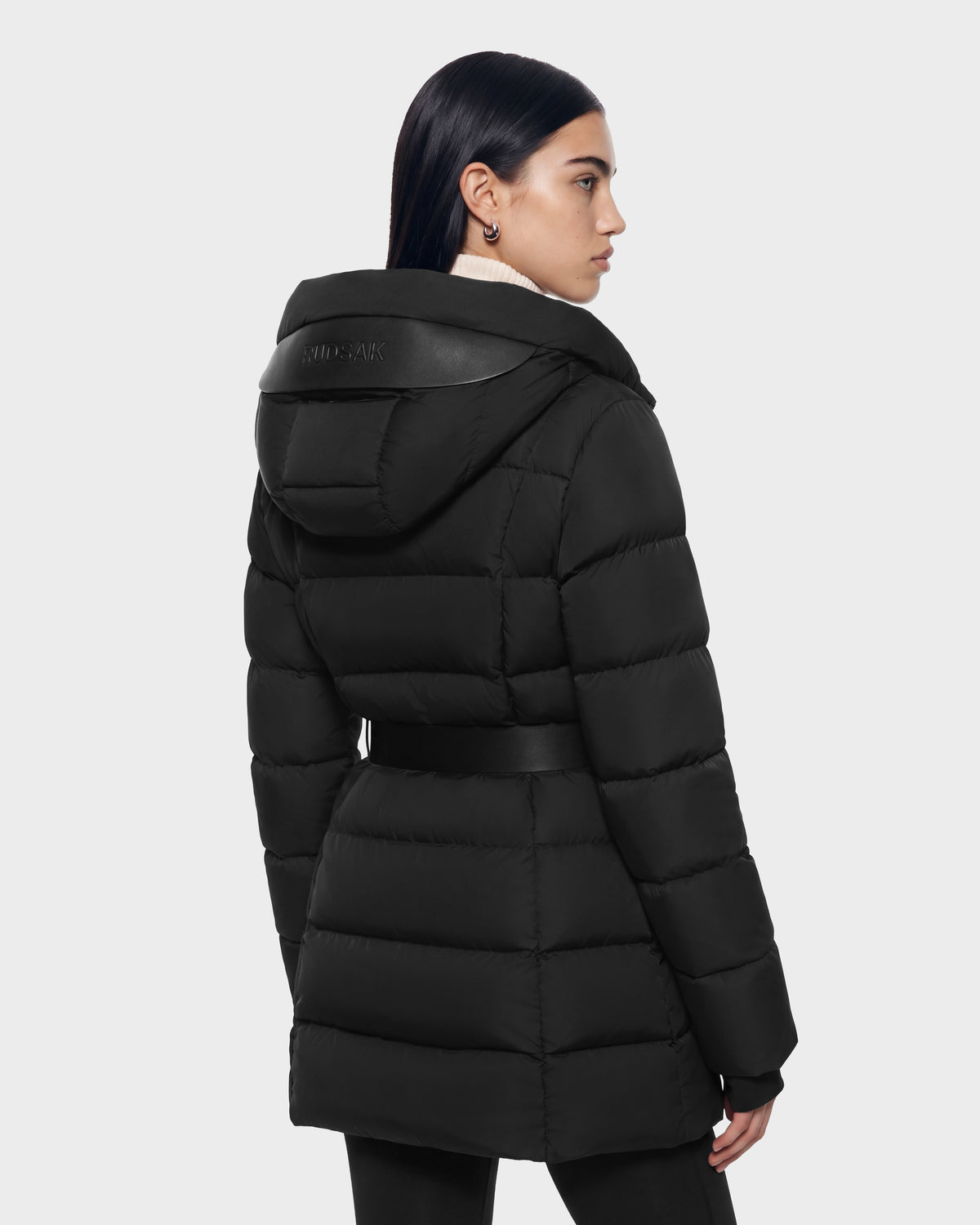 A Rudsak TAYLOR M - 8125965 Black puffer coat featuring a belted waist and a hooded back with leather-trimmed detail.