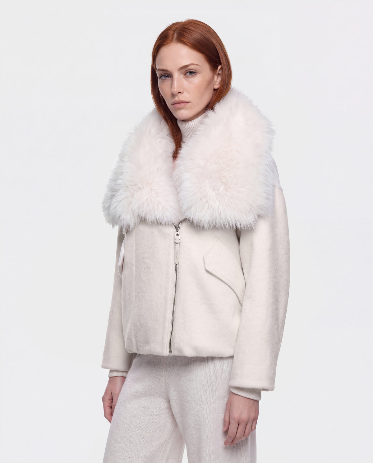 A person wears a ZARIA - 8126999 Vanilla off-white winter puffer jacket with a large, fluffy faux-fur collar.