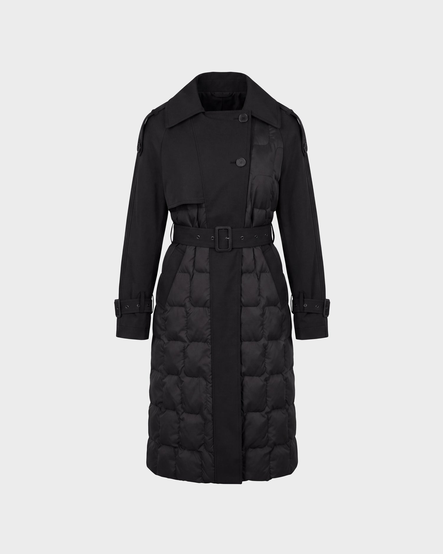 The Rudsak ELVIE - 8126512 Black is a long black trench coat featuring a quilted lower section, belted waist, button closures, and buckled strap cuffs, displayed on a plain light background.