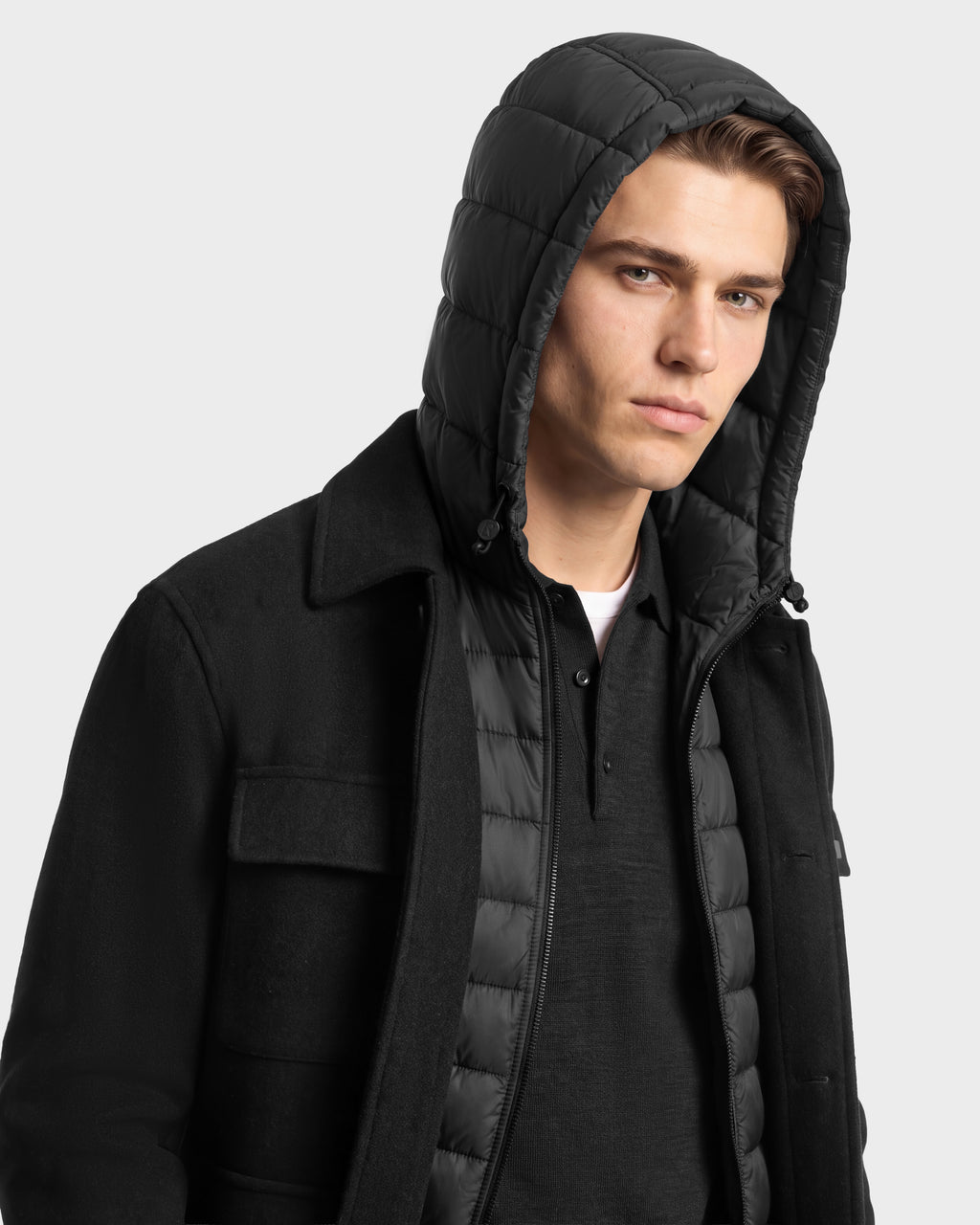 A man wearing the BRUNO - 6126716 Charcoal shirt jacket layered over a quilted, hooded vest.