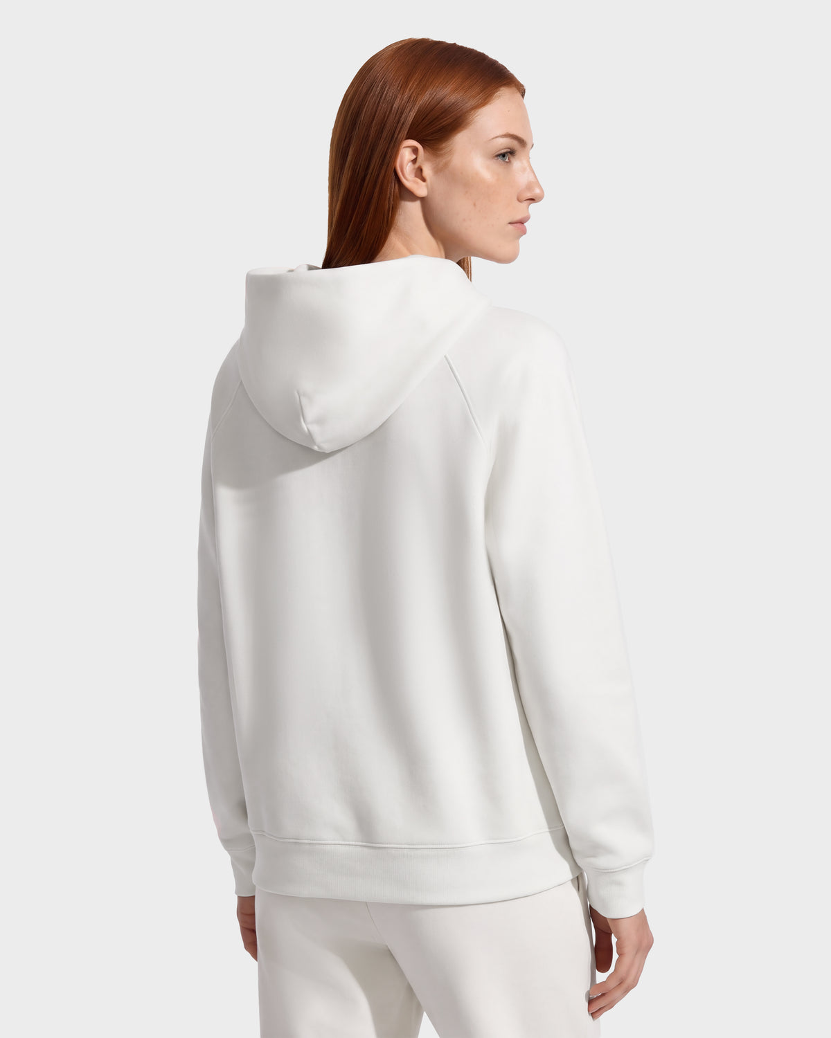 A person seen from the back wearing a BRIAR - 9525001 Vanilla W casual, unisex hoodie in a white cotton blend.