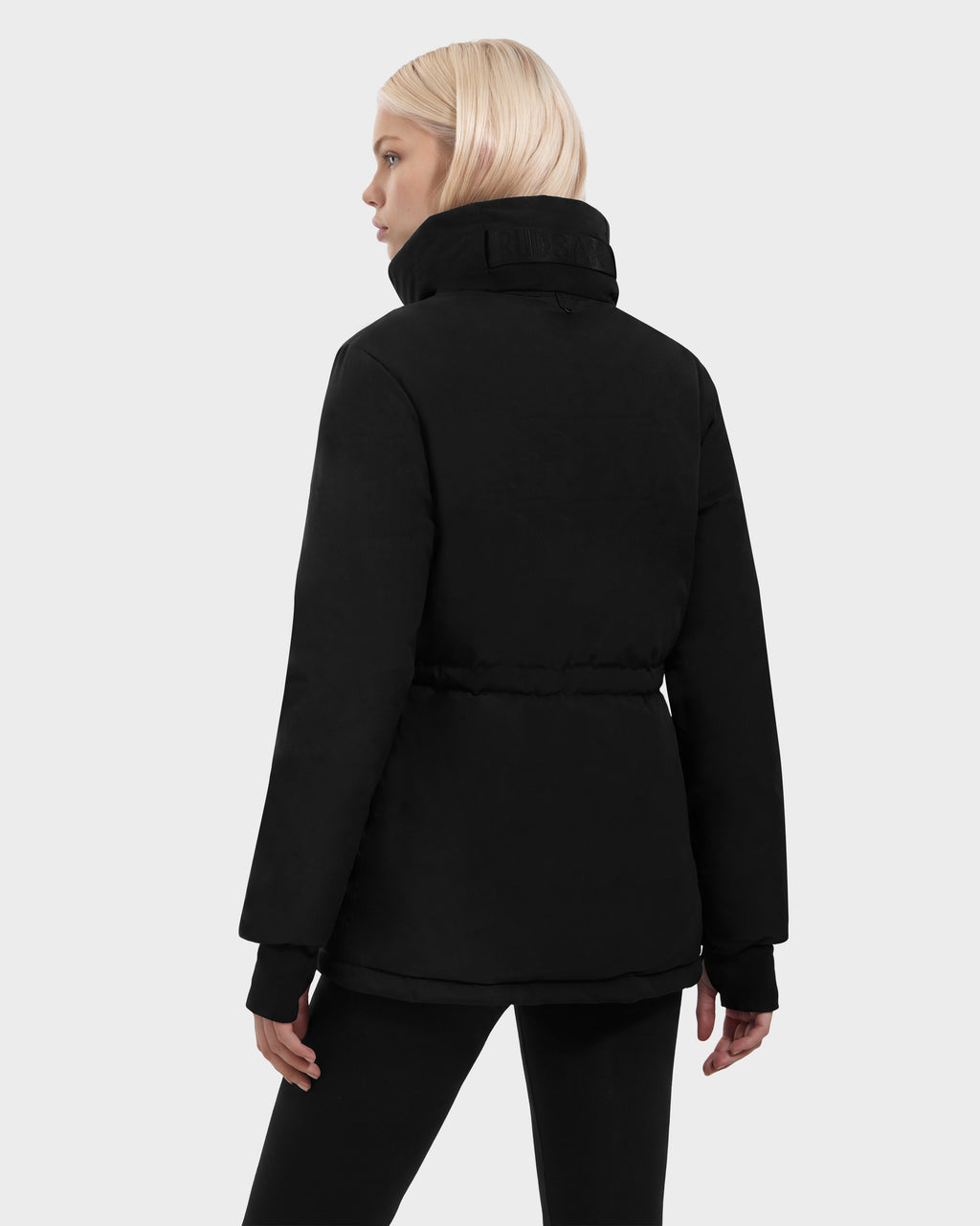 Back view of a person wearing a black BHIMA - 8126515 Rudsak puffer jacket with a cinched waist and high collar.