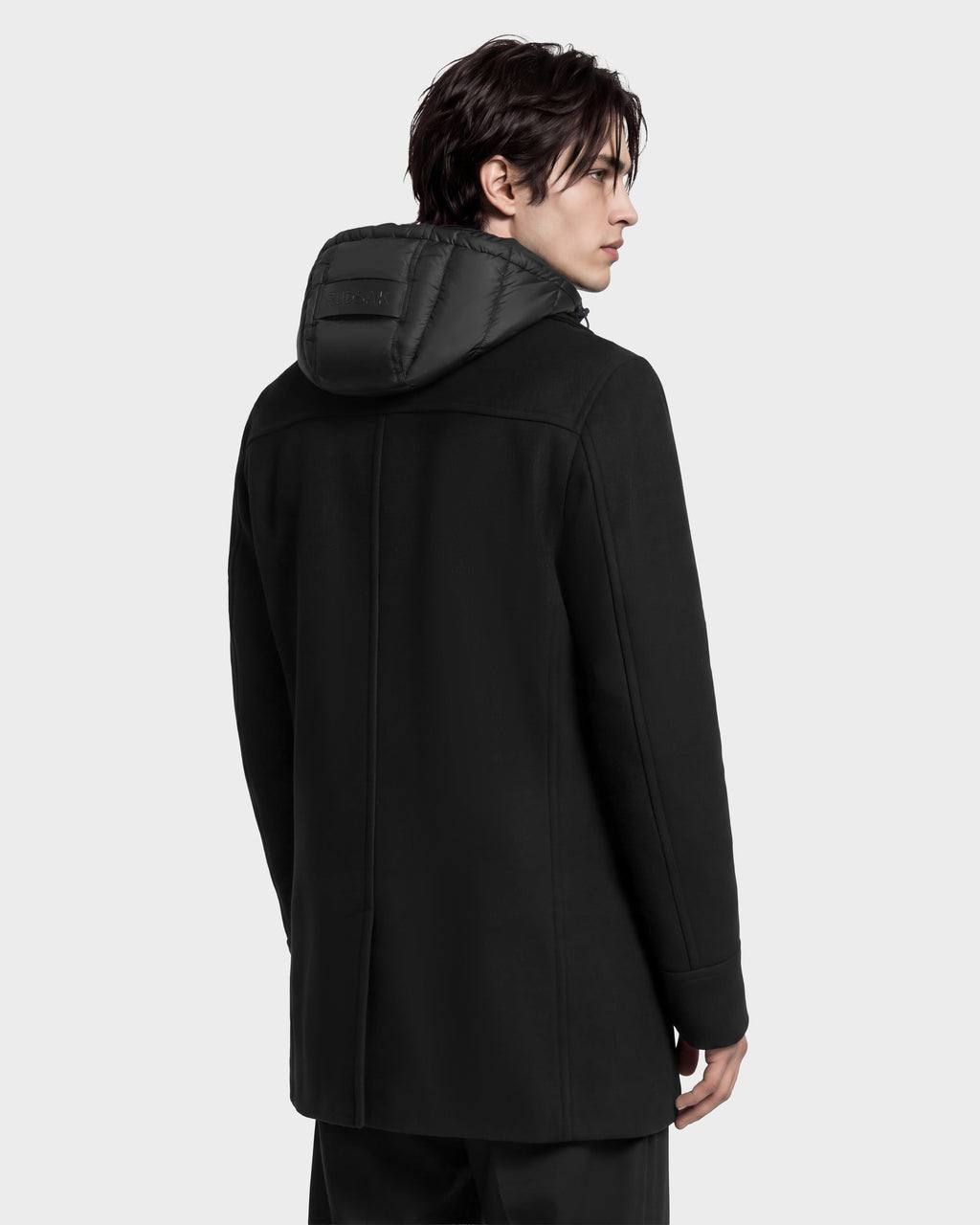 A man in profile wears a black LUCIEN - 6126508 Black mid-length wool-blend coat featuring a black quilted hood with duck down insulation.