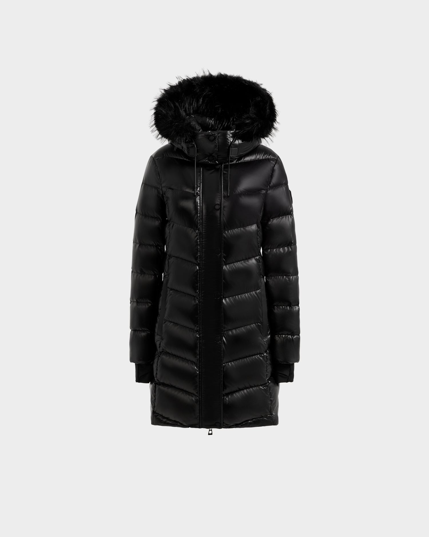 The ELISA S - L125572 Black by Rudsak is a long black quilted puffer jacket with a shiny finish, front zipper, horizontal quilting, ribbed cuffs, and a black faux fur-trimmed hood, shown on a plain light gray background.