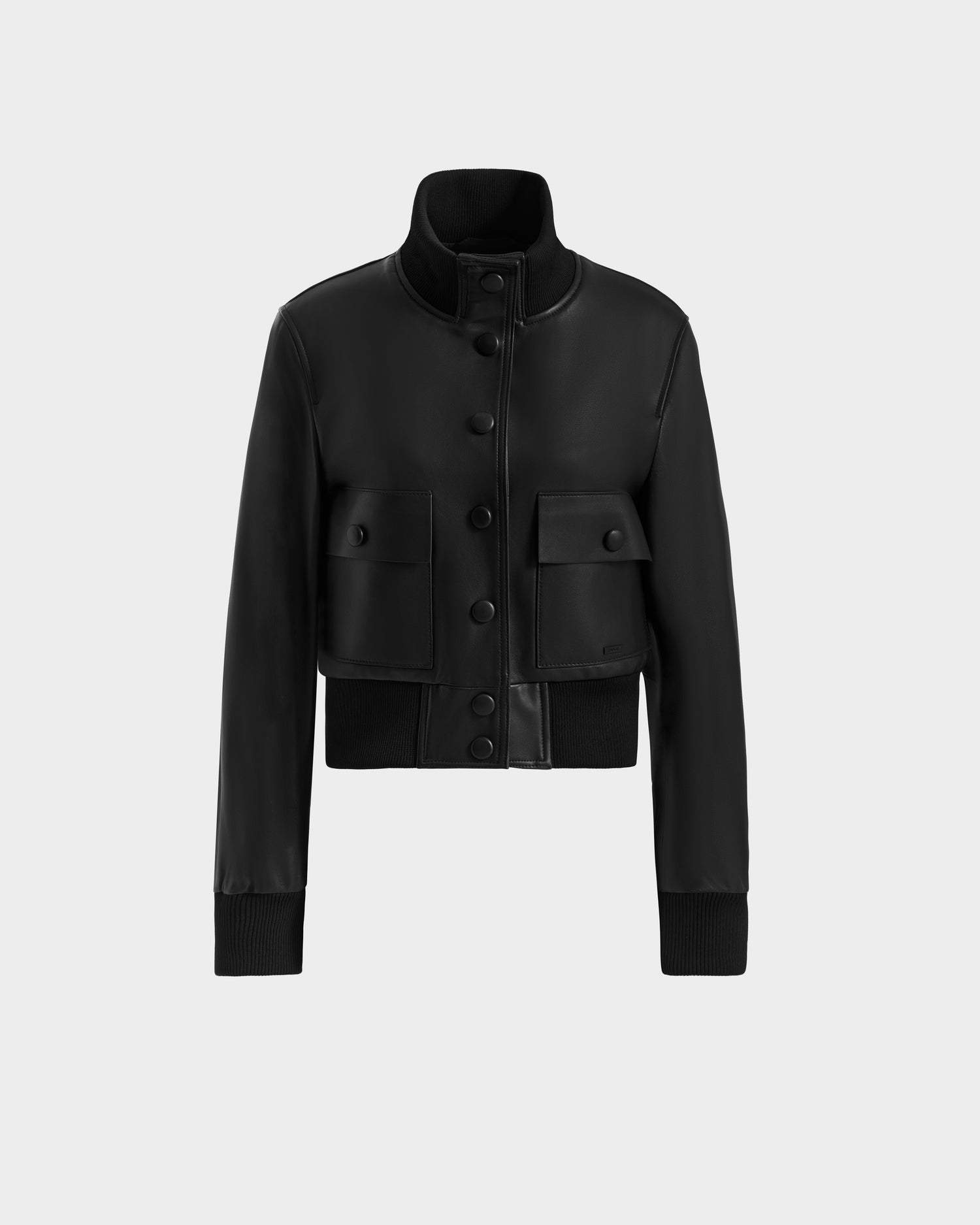 The EVERLEIGH - 8125547 Black women’s leather bomber jacket by Rudsak features a high collar, button-up front, large flap pockets, and ribbed cuffs and hem, displayed on a plain light gray background.