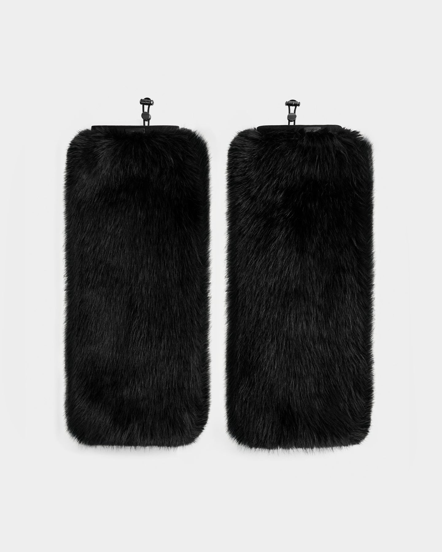 The PAIGE - 8425534 Black leg warmers by Rudsak feature rectangular black faux fur and clips at the top—an elegant women’s winter accessory, ideal for après-ski chic style. Displayed side by side on a plain light background.