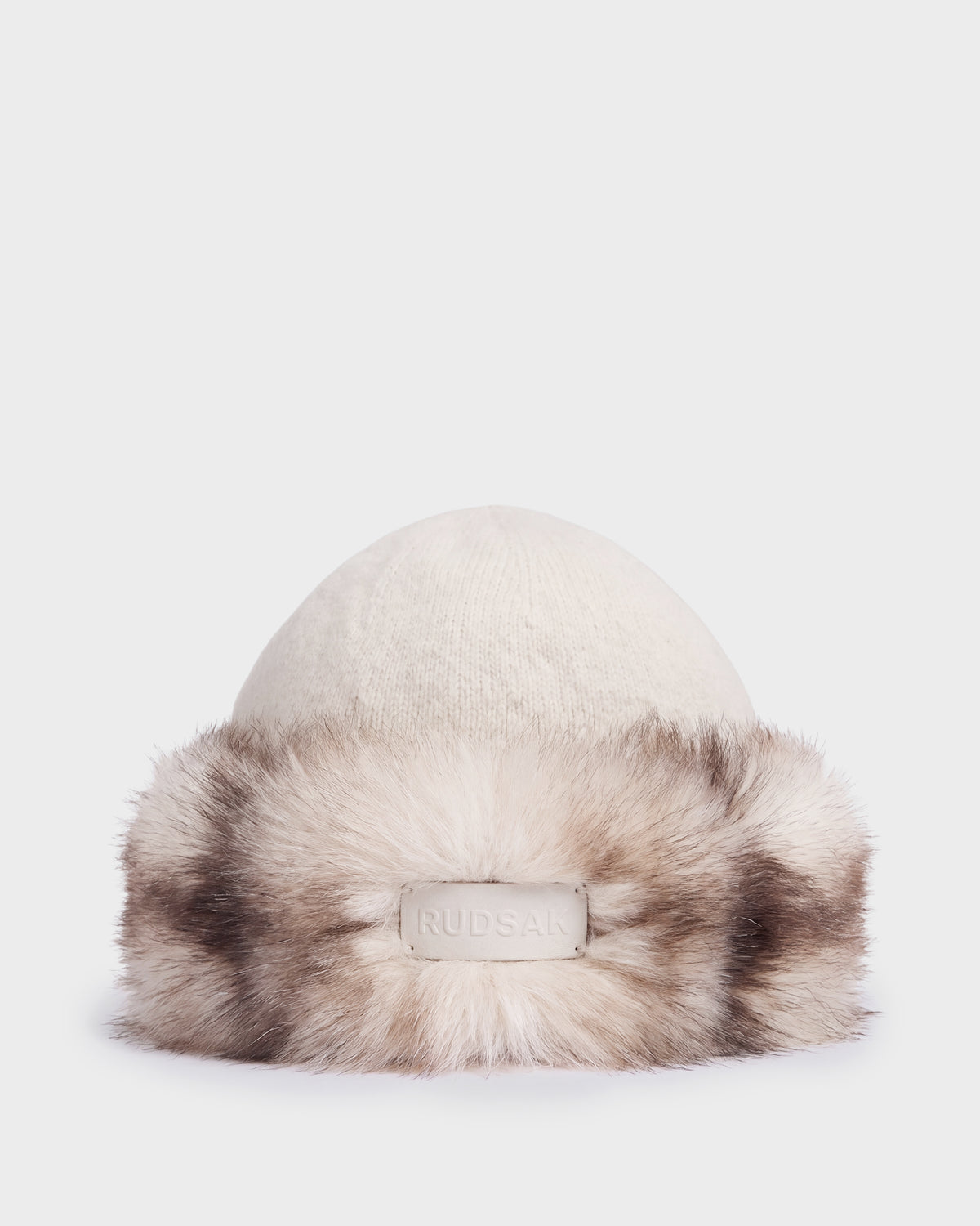Cream-colored LORETTA W - 8426510 Vanilla knit beanie with a wide, fluffy faux fur trim and a branded patch on the front.