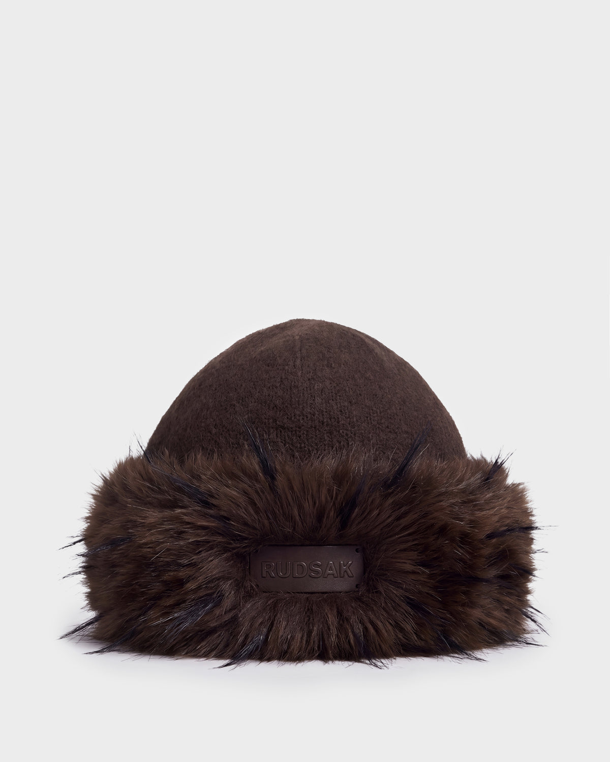 Dark brown LORETTA W - 8426510 Espresso knit hat by RUDSAK, featuring a wide faux-fur brim and a branded leather patch at the front.
