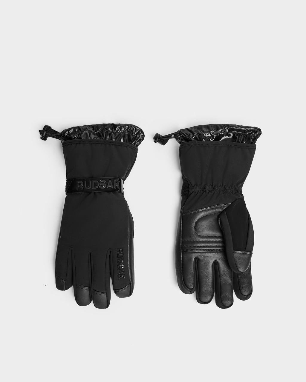A pair of black Rudsak ALPEN - 6424505 insulated winter gloves with adjustable wrist straps and shiny, elasticized cuffs, displayed palm and back side up on a plain white background.