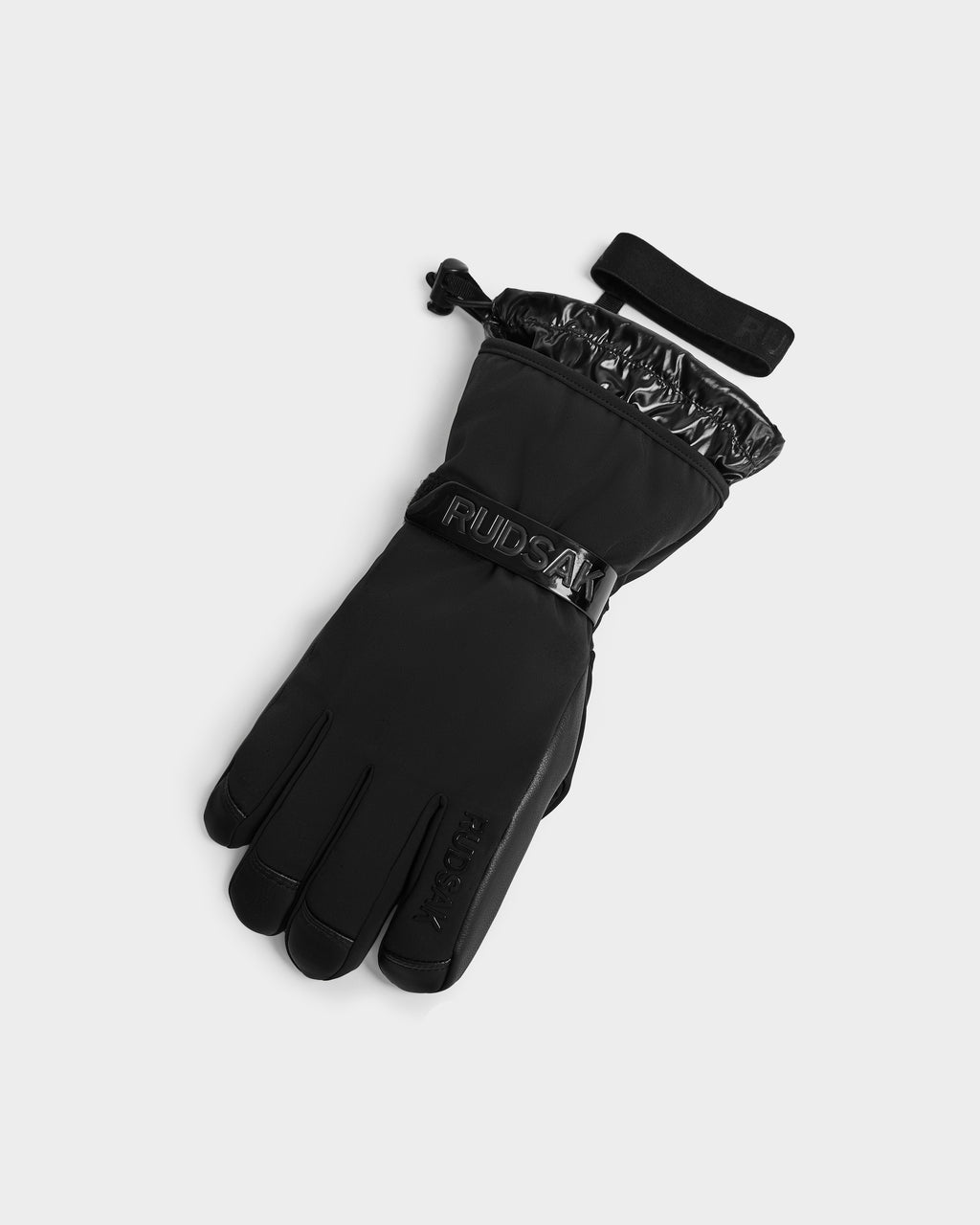A pair of black Rudsak APLEN - 6424505 insulated winter gloves with a wrist strap and adjustable drawstring, shown on a light gray background. These gloves offer a sleek design with subtle embossed branding.