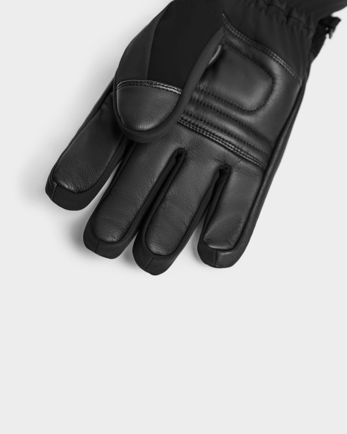 A close-up of the Rudsak APLEN - 6424505 Black insulated glove showcases padded detailing on the back of the hand and fingers, set against a plain light gray background.