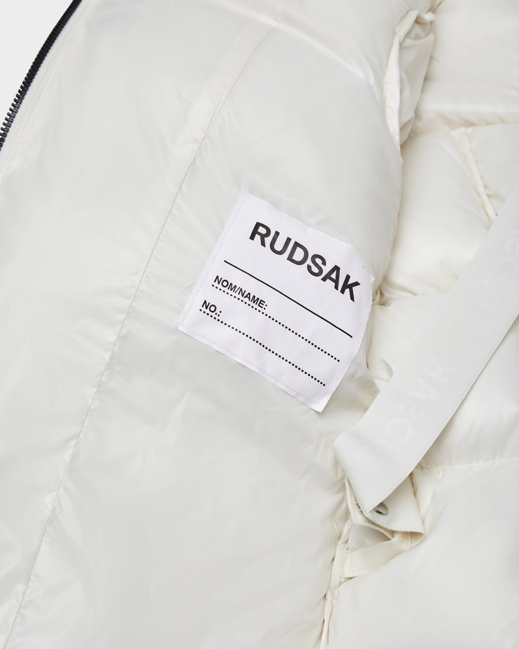 The Rudsak AUDREY K - 0124504 Iceland is a white, water-repellent girls down puffer jacket with a matching white label.