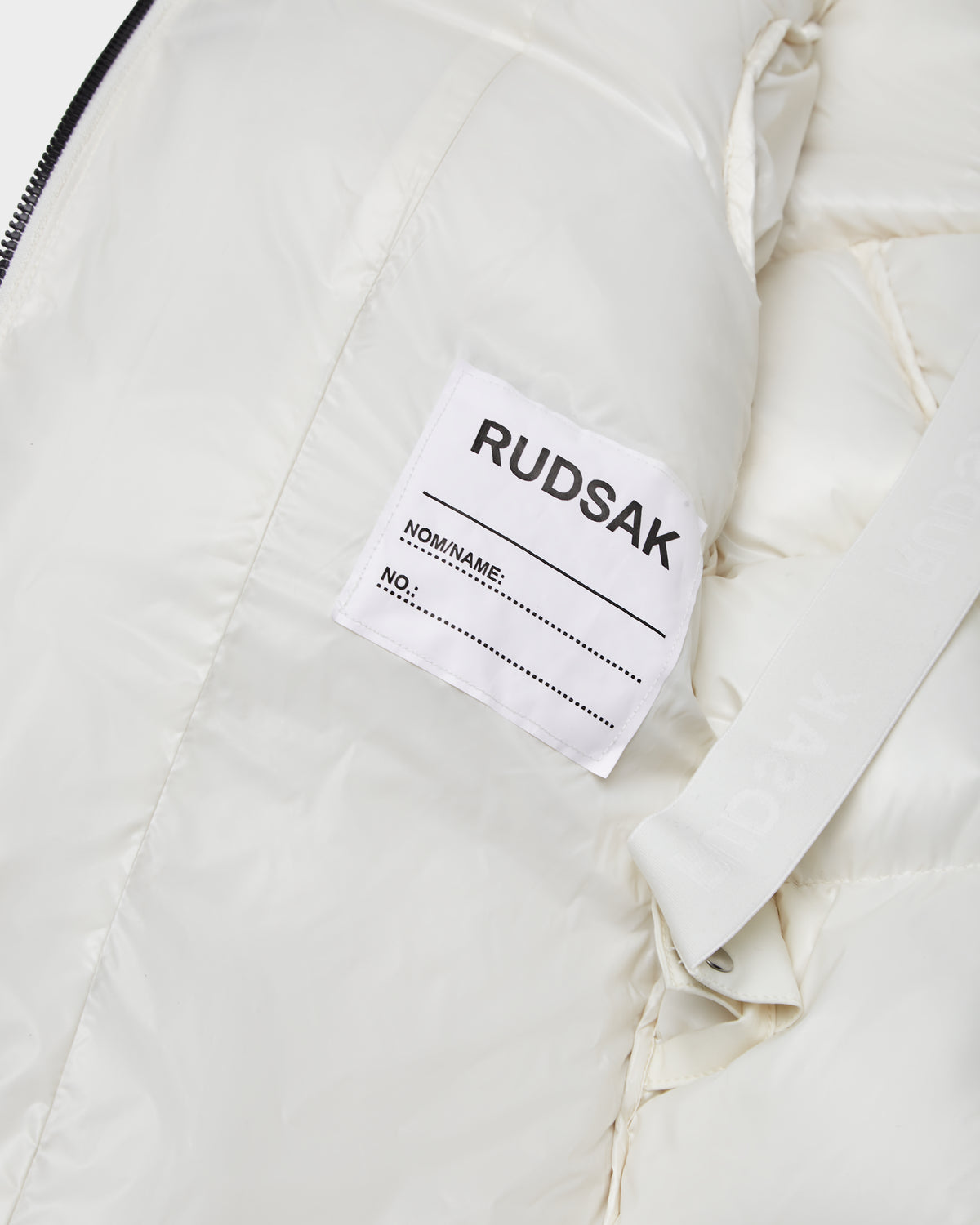 The Rudsak AUDREY K - 0124504 Iceland is a white, water-repellent girls down puffer jacket with a matching white label.