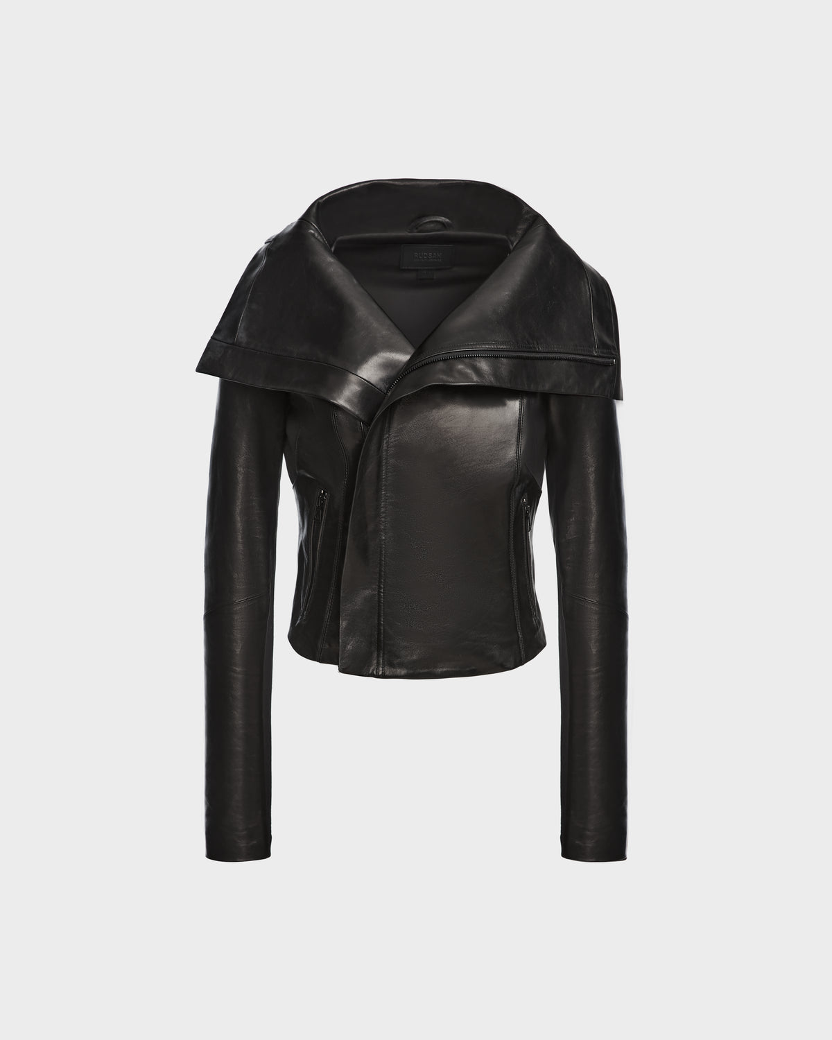 The AVRIL - 8124561 Black womens leather jacket by Rudsak features a wide asymmetrical lapel and fitted sleeves, showcased on a plain white background.