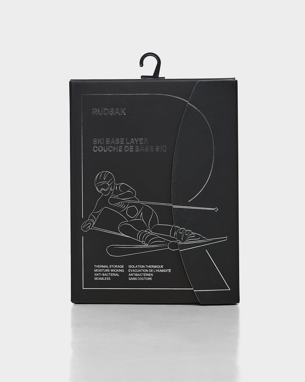 A black rectangular package for the Rudsak CARRIE - 8524619 ski underlayer features a minimalist white skier line illustration. Packaging details are in English and French and highlight women’s stretch set thermal performance.