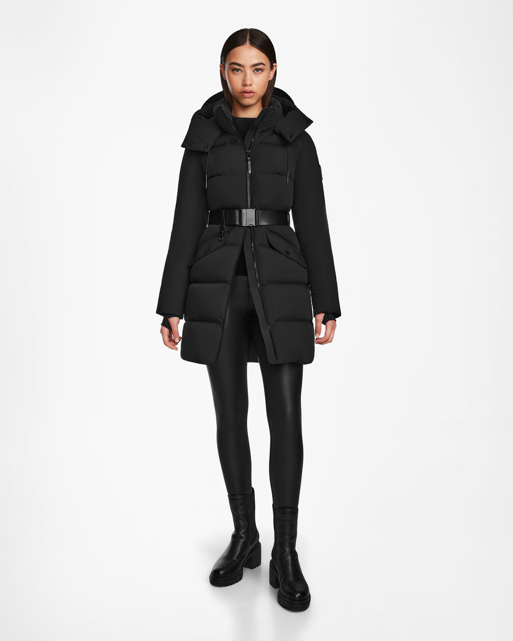 A woman in a black mid-length Rudsak CAT - 8124584 puffer coat showcases the sleek, RDS-certified down design of this essential.
