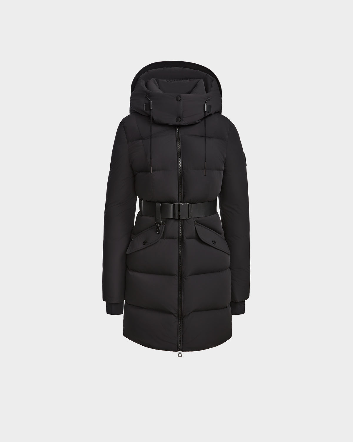 The Rudsak CAT - 8124584 Black is a mid-length women’s quilted down puffer coat with hood, front zipper, snaps, large pockets, belted waist, ribbed cuffs, and adjustable drawstring. Filled with RDS-certified down. Shown on plain white background.
