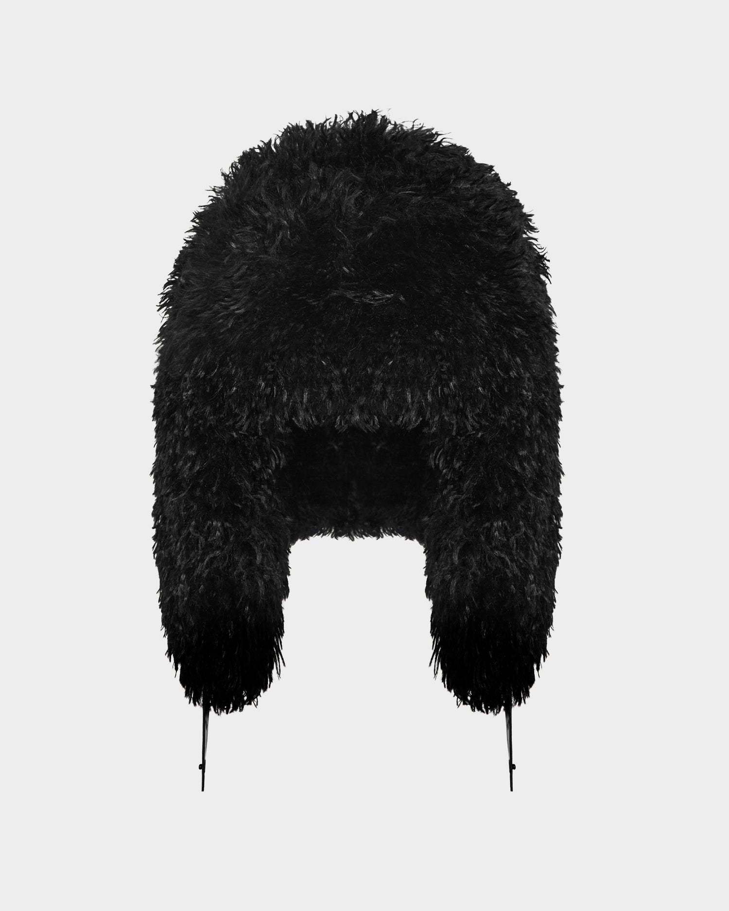 The Rudsak DARBY M - 9424510 Black is a unisex aviator-style hat in black faux Mongolian fur, with ear flaps and adjustable chin straps, shown on a plain light gray background—an ideal winter accessory.