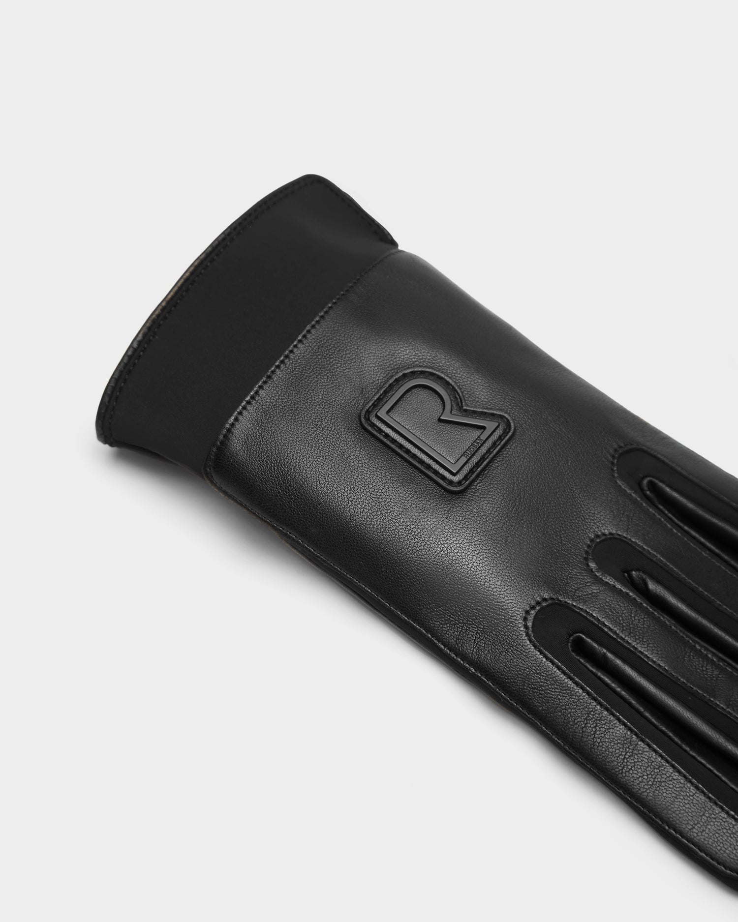 The EDDIE - 6424504 Black men’s leather gloves by Rudsak feature a raised R detail, sleek stitching, and a smooth cuff. Displayed on a plain background, these stylish winter gloves are both fashionable and practical.