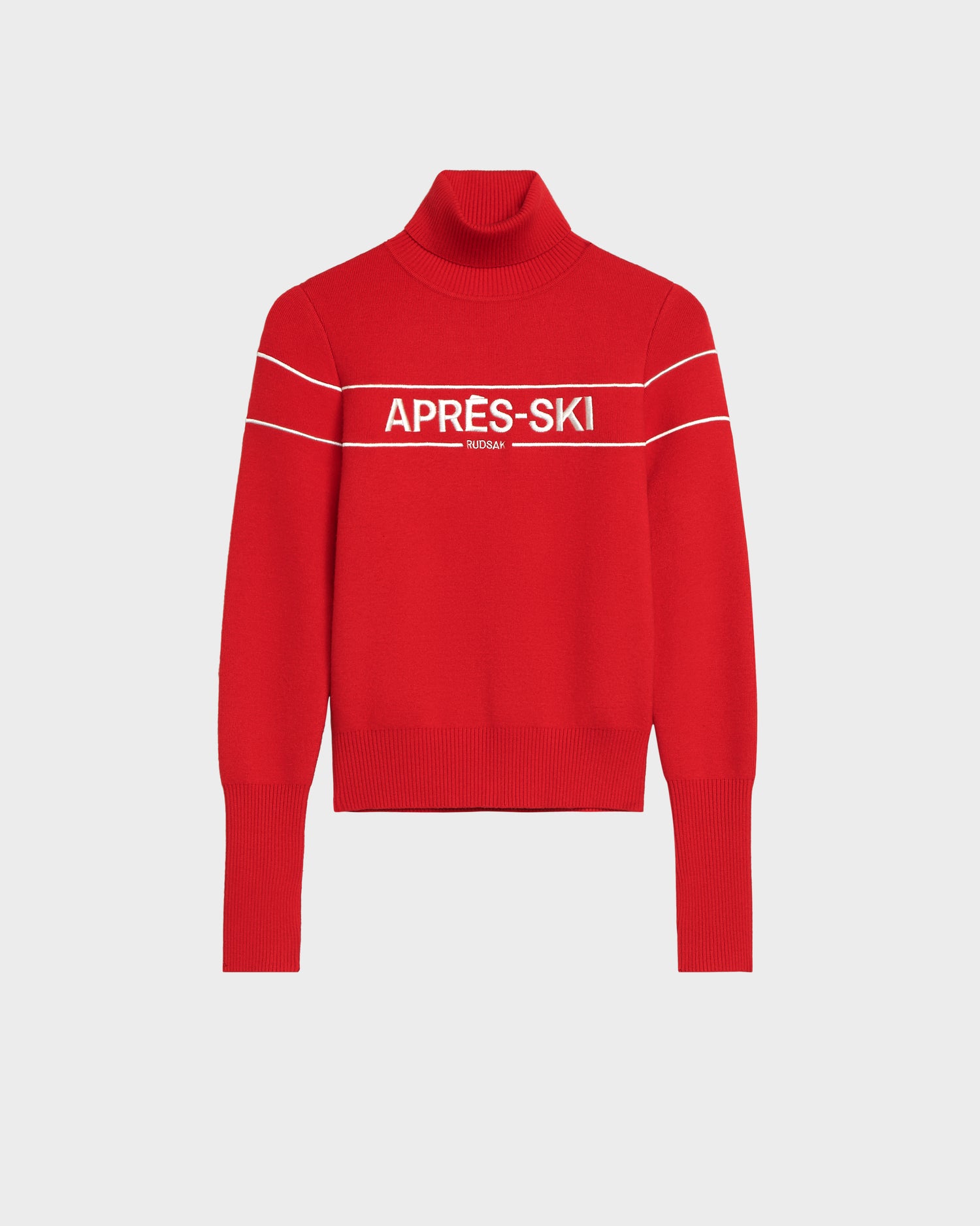 The Rudsak ERIKA - 8523536 Flame Red turtleneck sweater features long sleeves, two white stripes, and “APRÈS-SKI” in bold white letters—perfect for adding a vibrant touch to your winter wardrobe.