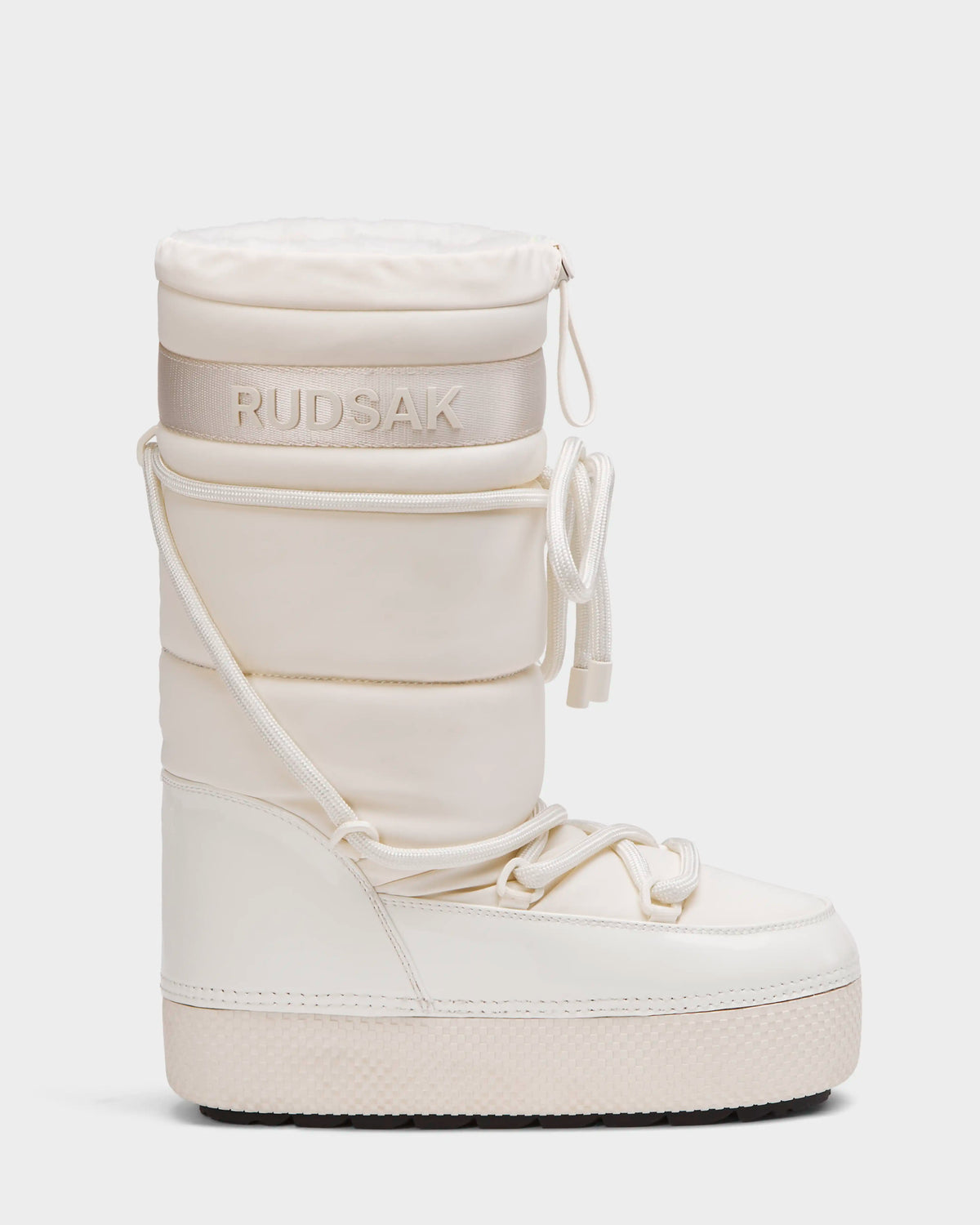The FARAH L - 8224542 Iceland by Rudsak is a tall, white women’s winter boot with a padded, insulated look, flat sole, lace-up details, water-repellent finish, Rudsak branding near the top, and warm faux fur lining for cold weather.