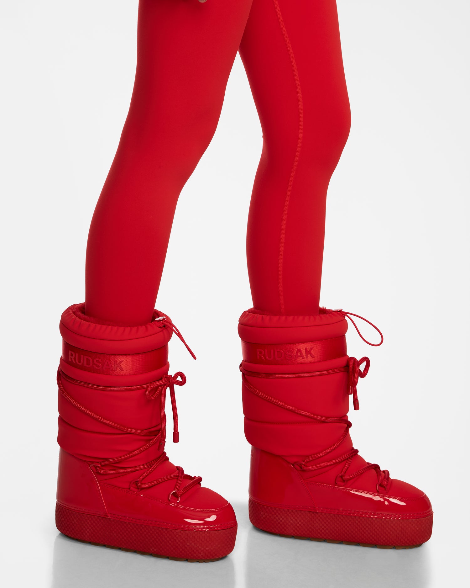 A person wearing Rudsaks FARAH - 8223501 Flame Red tights and water-repellent boots.