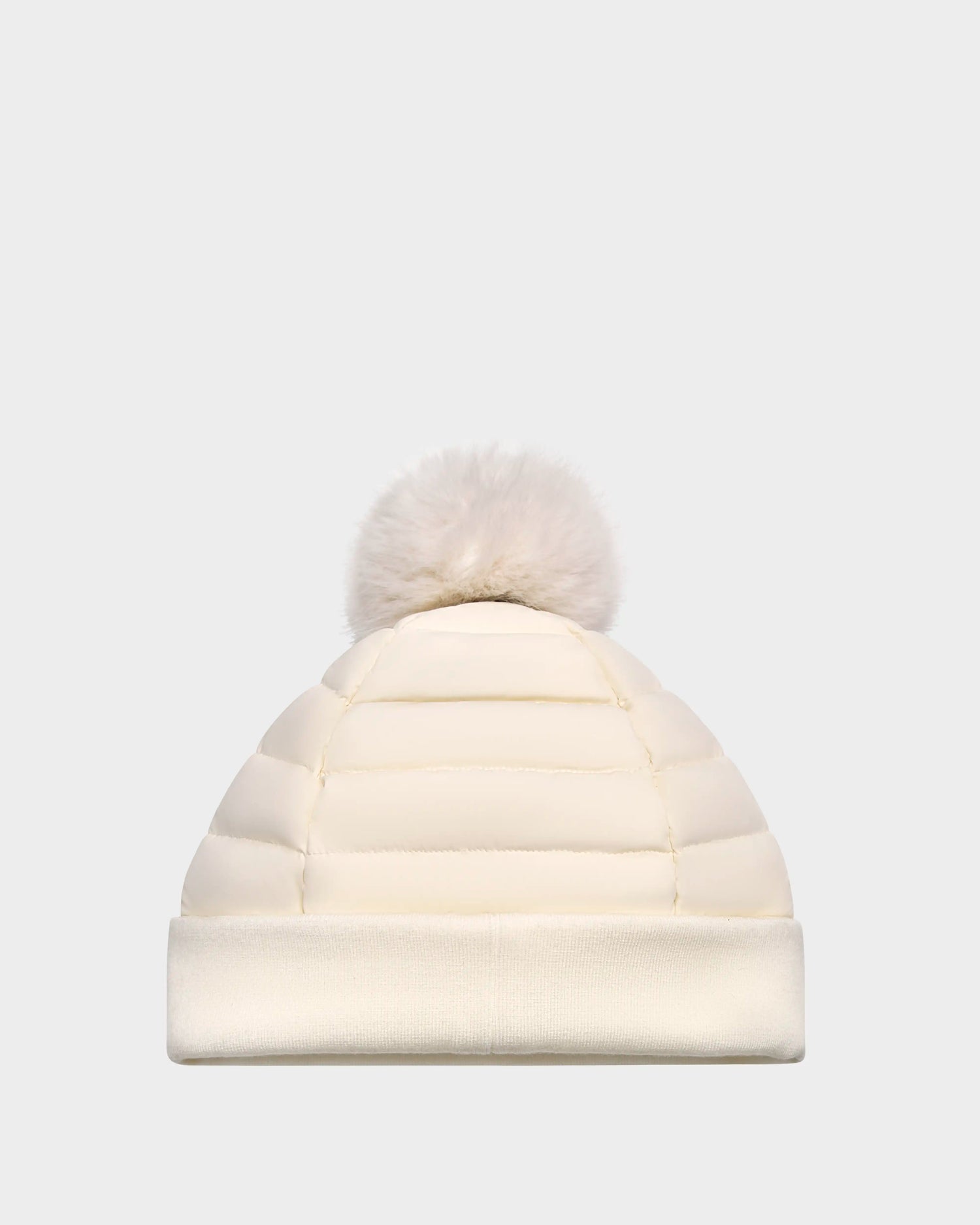 The Rudsak GALA - 8424514 Iceland is a cream womens quilted down puffer hat with a large faux fur pom pom and folded brim, shown on a plain light gray background.
