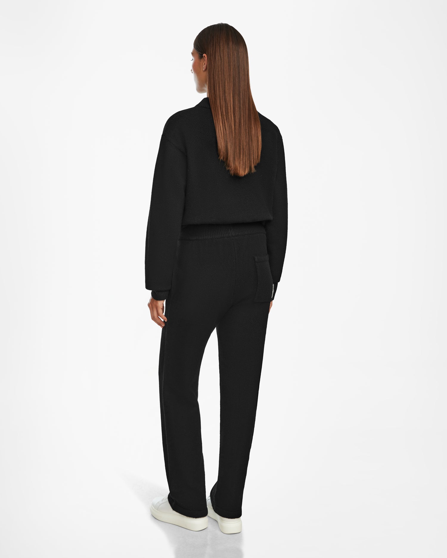 A woman in a black outfit featuring Rudsak GEIGER - 9524512 Black W pants.