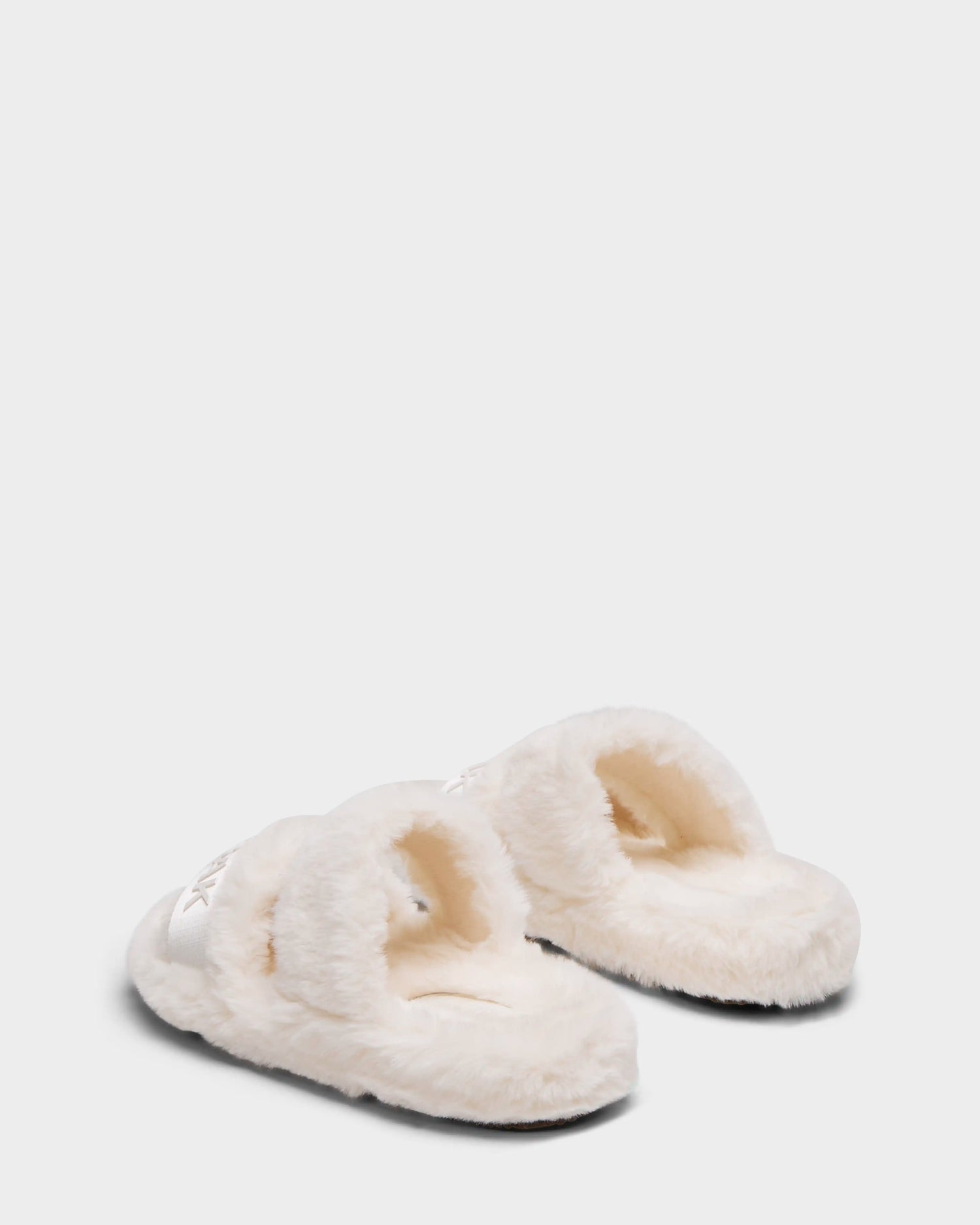 A pair of Rudsak GEMA - 8223510 Iceland women’s faux fur slippers with fluffy white, open-toe slides and wide plush straps, shown on a plain light gray background.