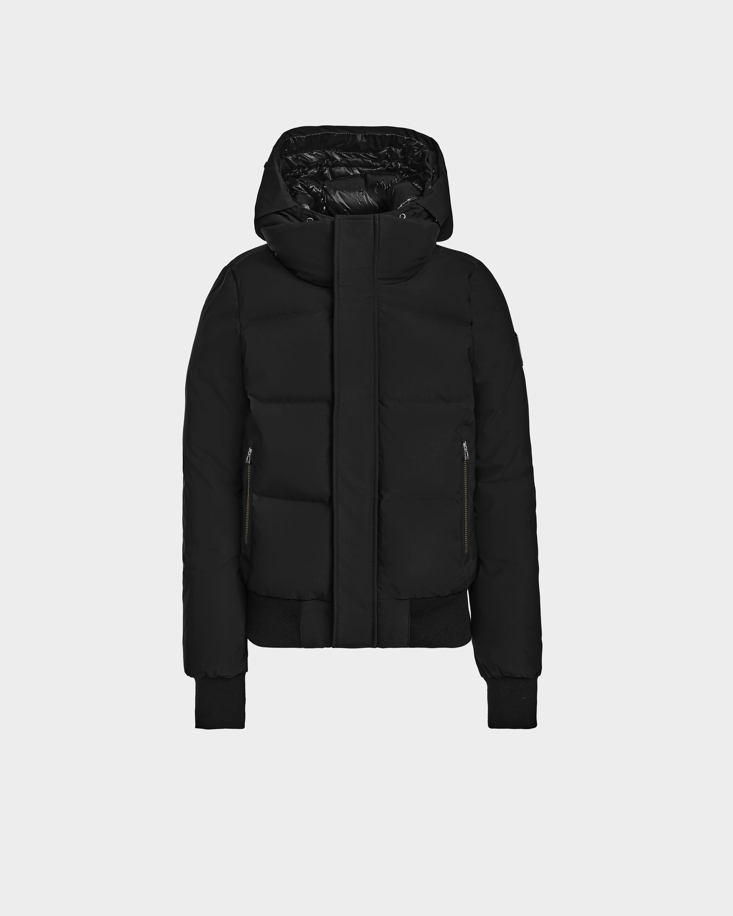 The Rudsak JORDY - 9123513 Black M unisex down puffer jacket features a hood, front zipper, side pockets, and ribbed cuffs and hem, shown against a plain white background.