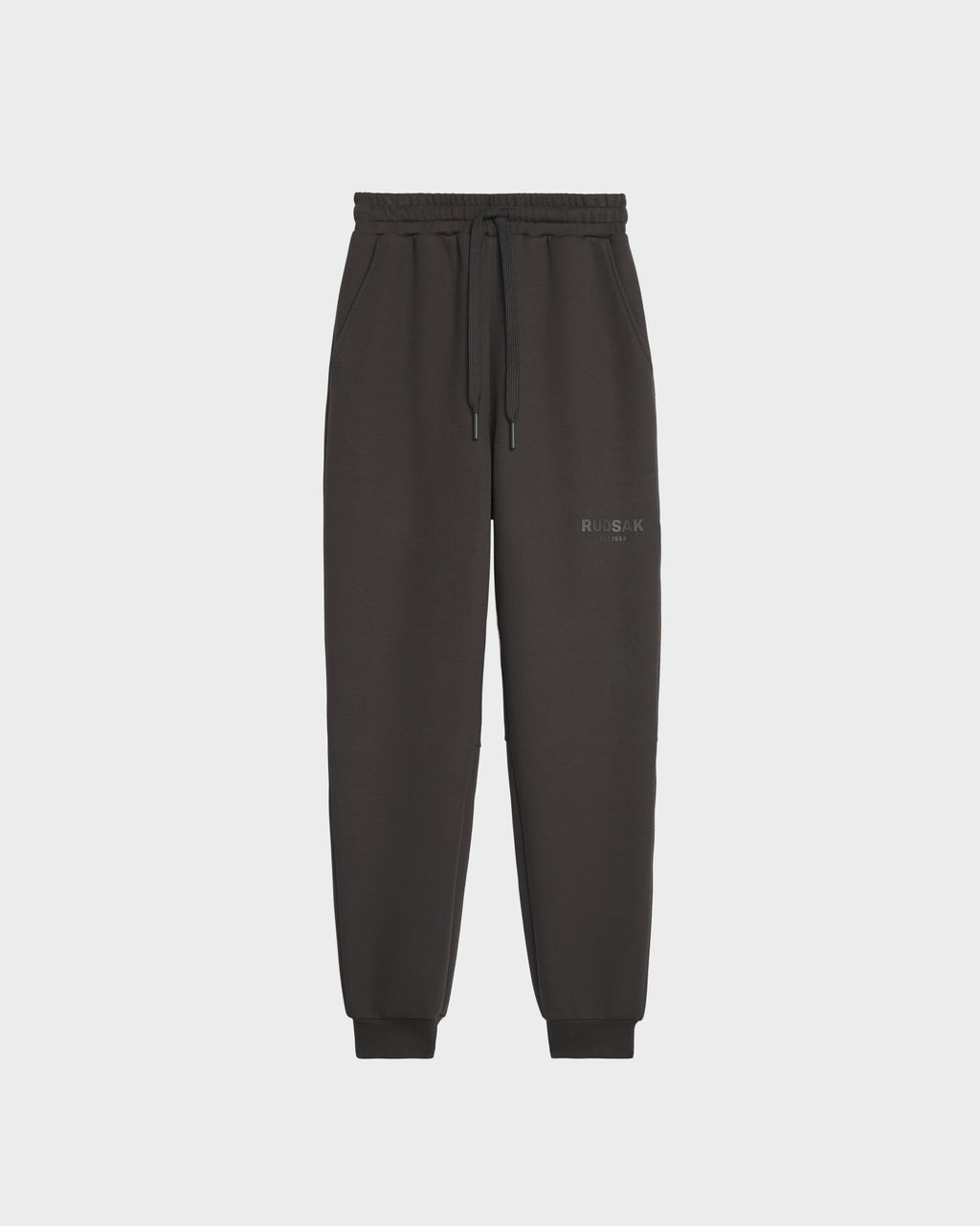 The Rudsak JOSS - 9524009 Grey W jogger sweatpants feature premium cotton, an elastic waistband with adjustable drawstring, cuffed ankles, and subtle text on the left thigh, shown against a plain white background.