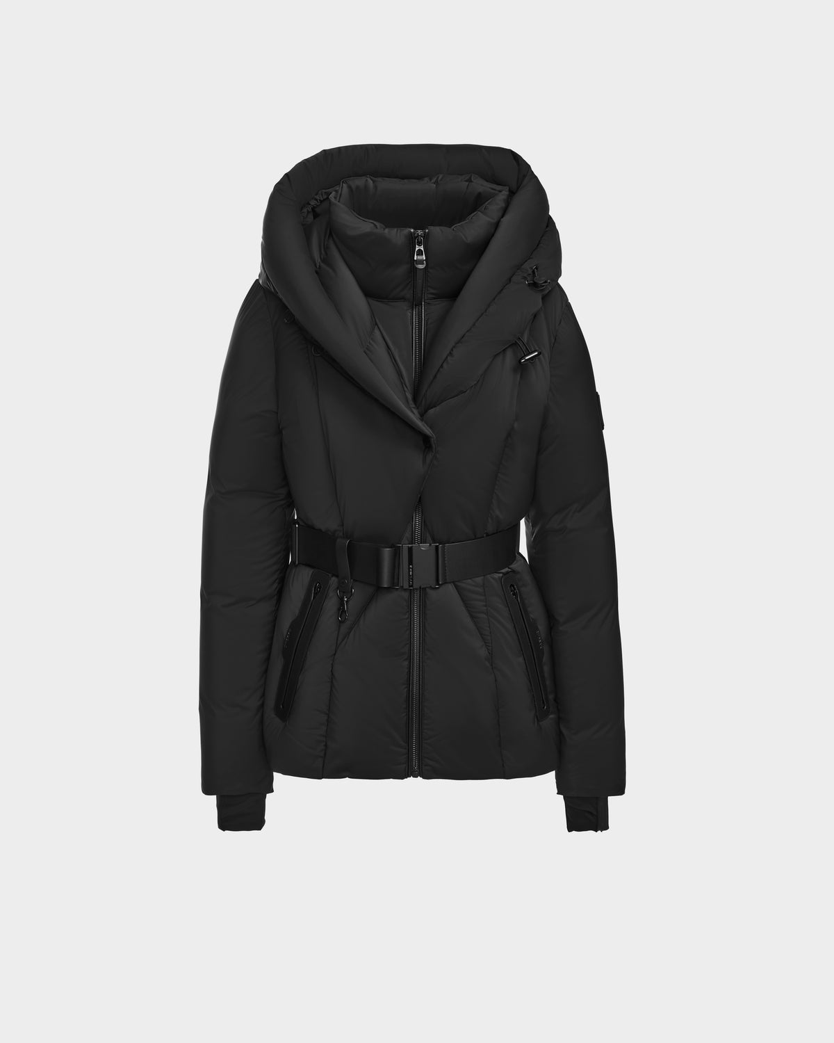 The Rudsak KOLAD - 8124528 Black is a short, fitted puffer jacket with vegan leather trims, large hood, belted waist, zip front, and zippered side pockets, shown on a plain light gray background.