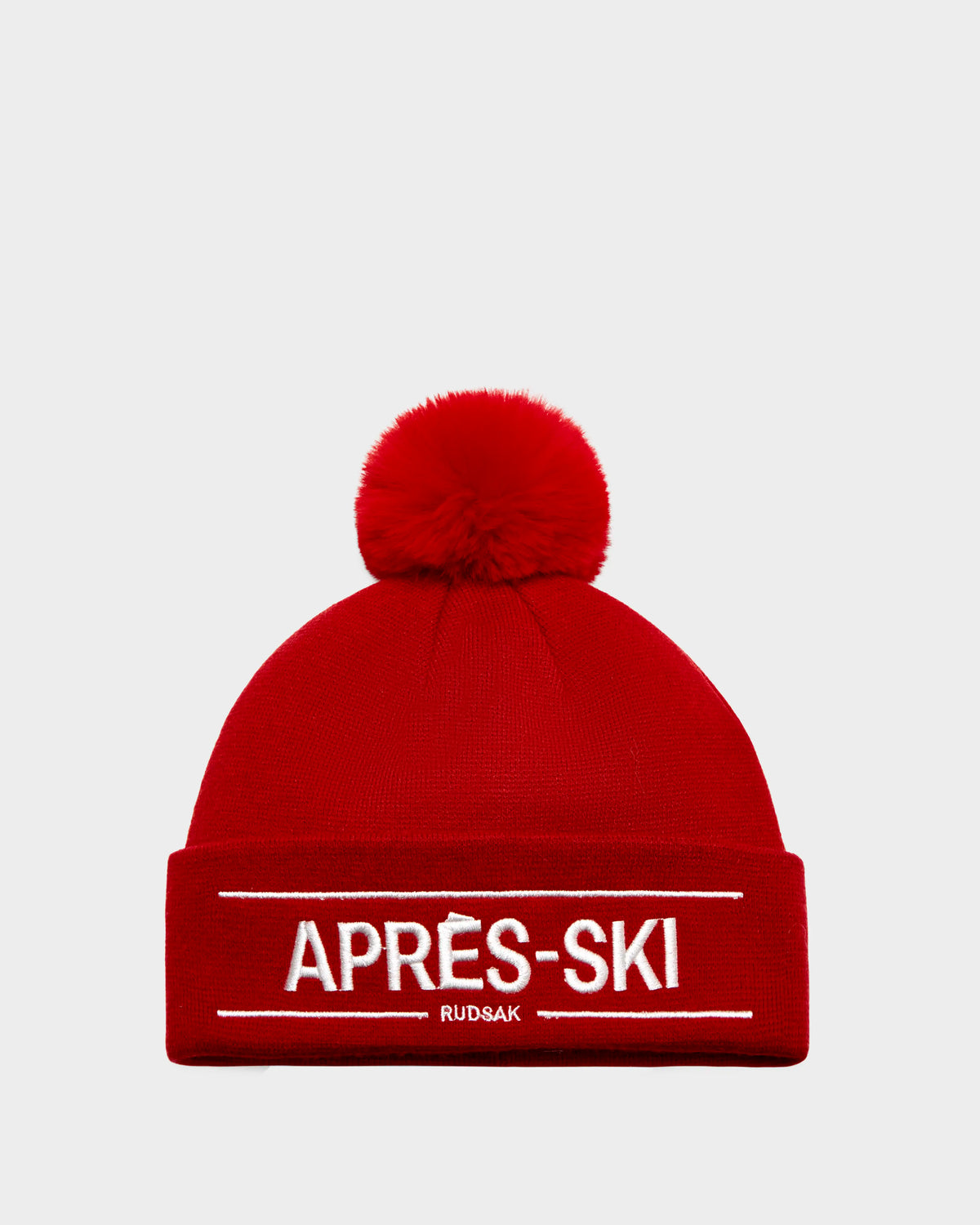 The KRISS - 9424500 Flame Red by Rudsak is a bright red unisex après-ski tuque with a large pom-pom, folded brim featuring bold white “APRÈS-SKI” and RUDSAK below—perfect for stylish cold-weather adventures.