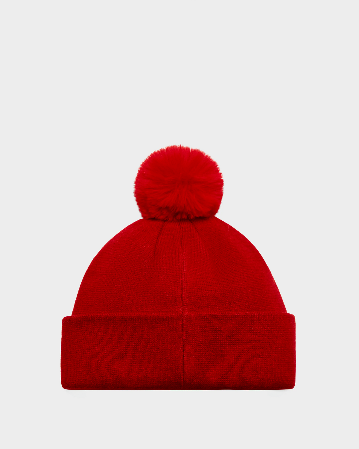 The Rudsak KRISS - 9424500 Flame Red is a vibrant red knit après-ski hat with a folded brim and a large pom-pom, shown against a plain light gray background.
