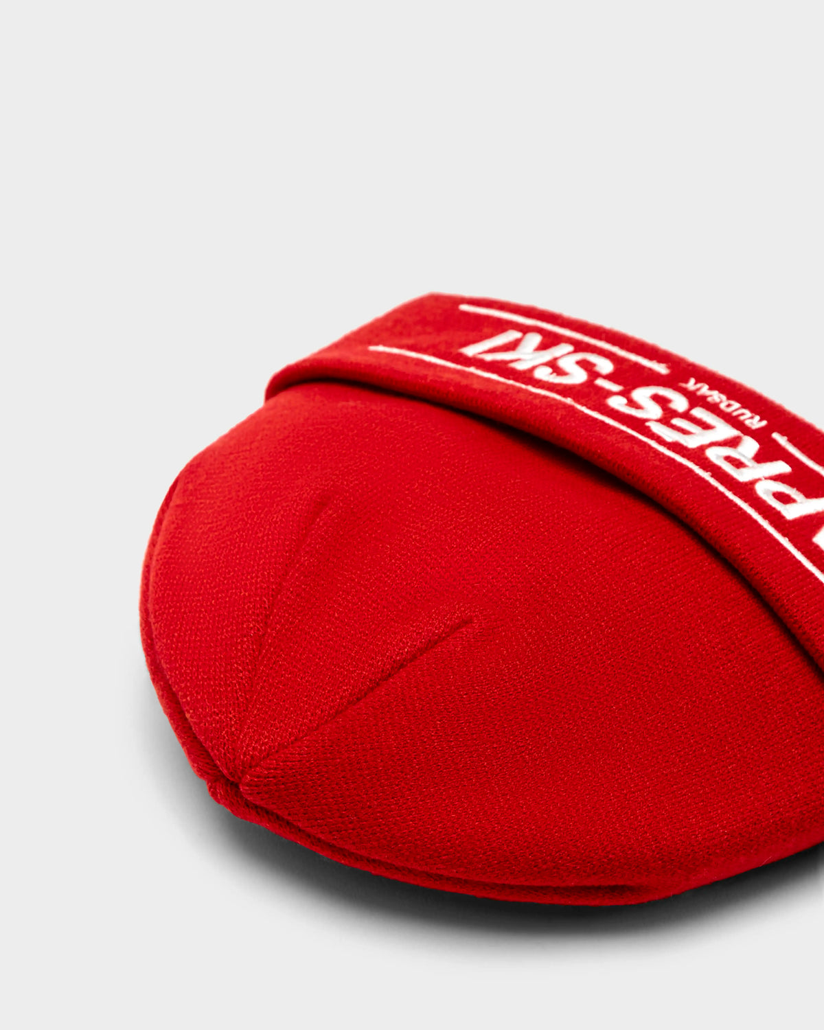 The KRISS - 9424500 Flame Red beanie by Rudsak is a unisex winter tuque featuring white text, ideal for adding both style and warmth to your cold-weather outfits.