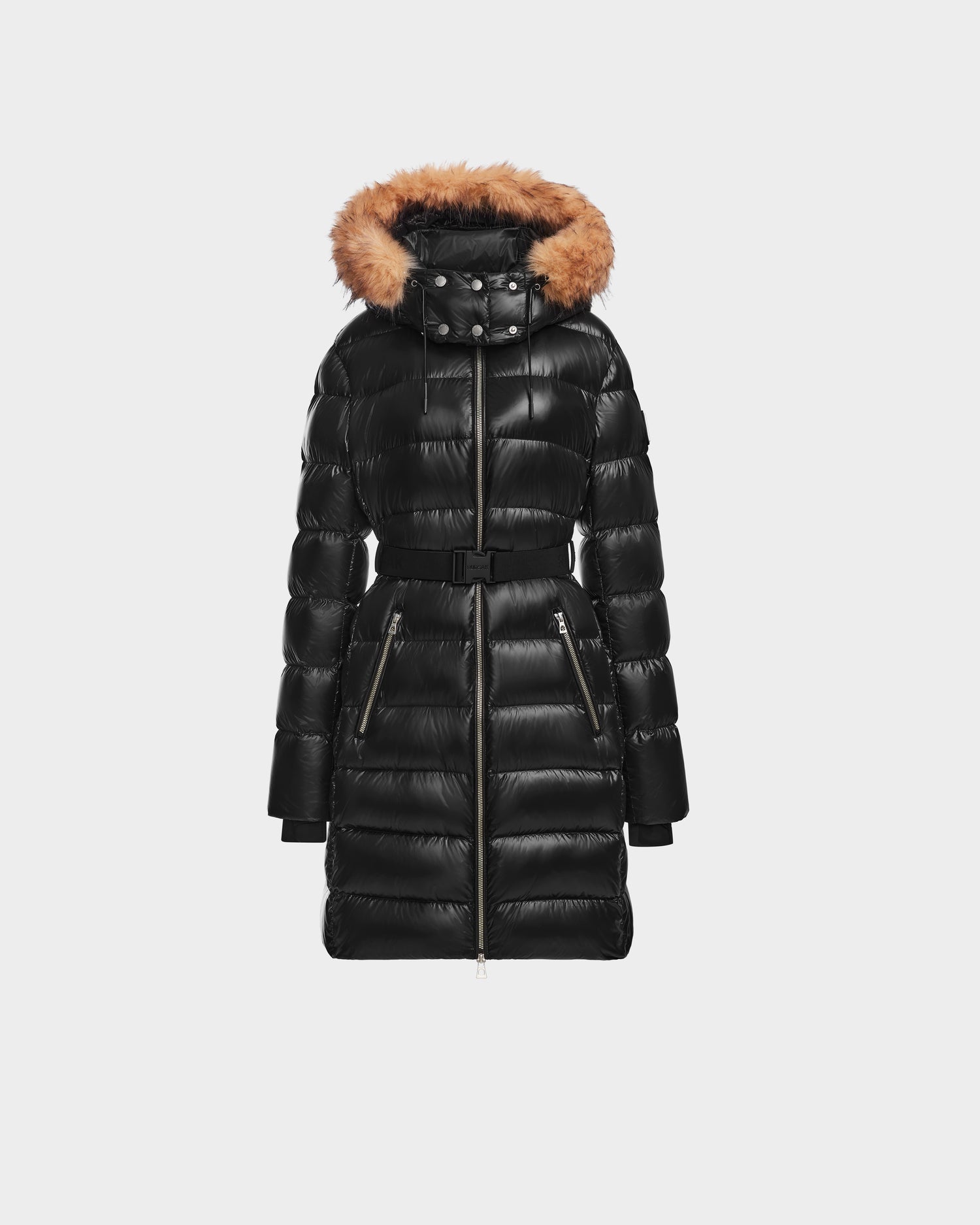 The Rudsak LILITH - L124539 Black is a long, black quilted winter coat with a belted waist, front zipper, zippered pockets, and a hood trimmed with brown faux fur, shown against a plain white background.
