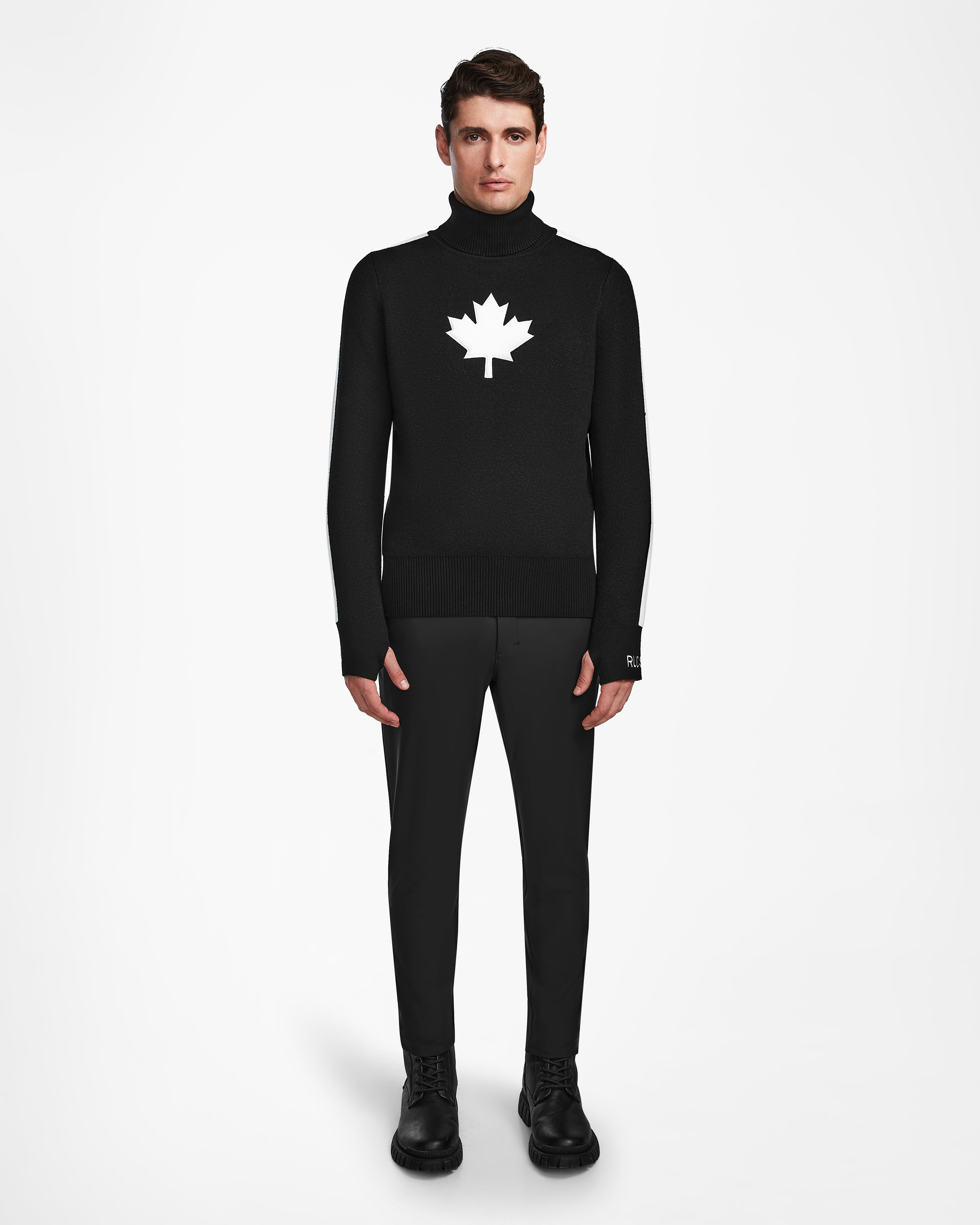 A man wearing the Rudsak LUKAS - 6524543 black turtleneck sweater and black pants.