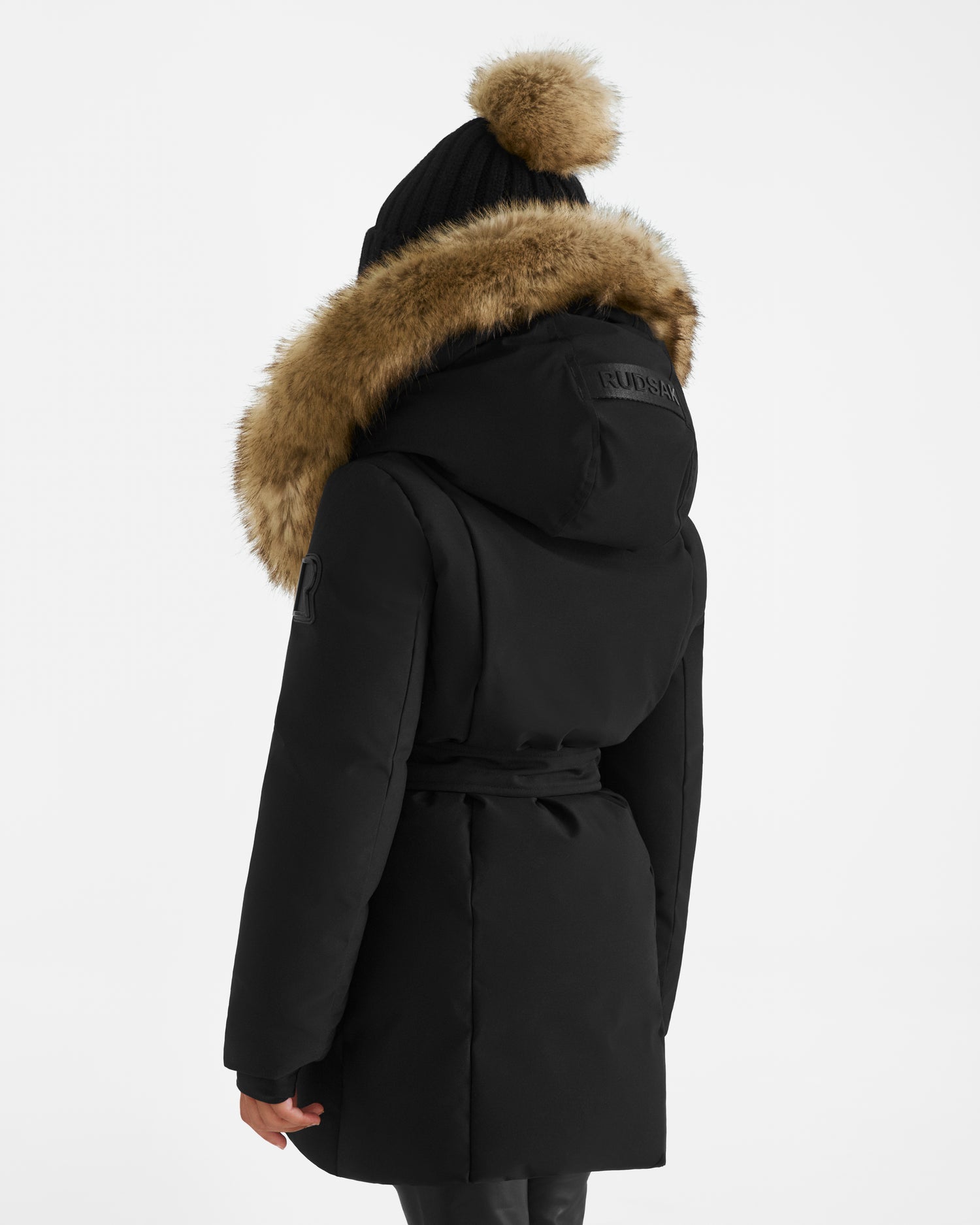 The Rudsak MODA K - 0124505 Black is a girls down parka crafted from recycled materials, featuring a cozy fur hood.