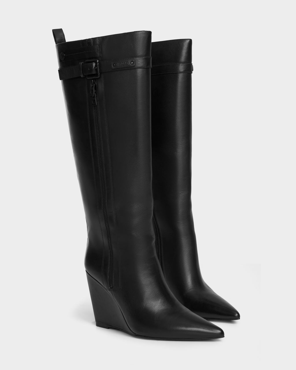 The NANCY - 8224507 Black womens wedge boots by Rudsak are crafted from smooth black leather with pointed toes, knee-high shafts, side zippers, and a chic buckle accent—perfect for elevating your style.