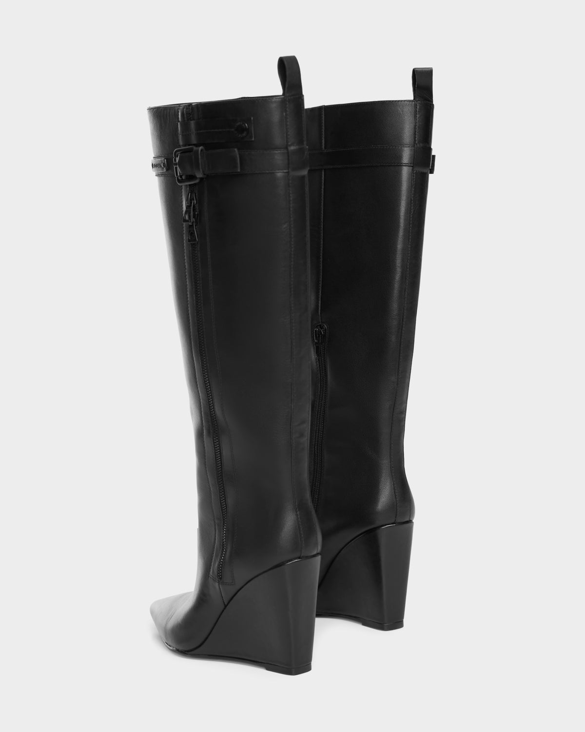 The NANCY - 8224507 Black womens wedge leather boots by Rudsak feature a tall silhouette, pointed toes, side zippers, and decorative buckle straps near the top, displayed against a plain light background.