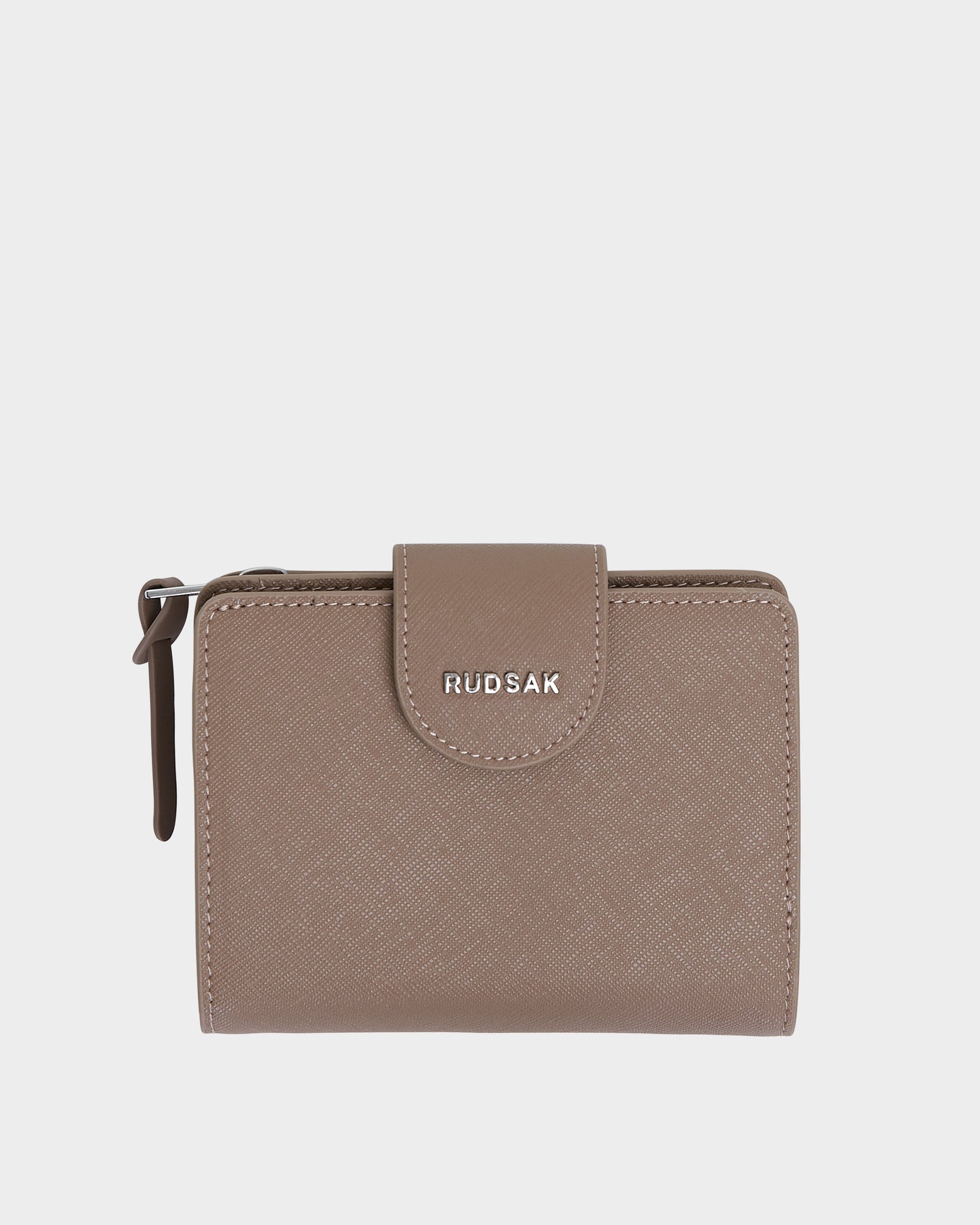 The Rudsak NOVALIE - L424500 Sand womens leather cardholder wallet features a textured taupe finish, front flap with silver brand logo, and a side zipper compartment—an elegant, compact accessory for everyday use.
