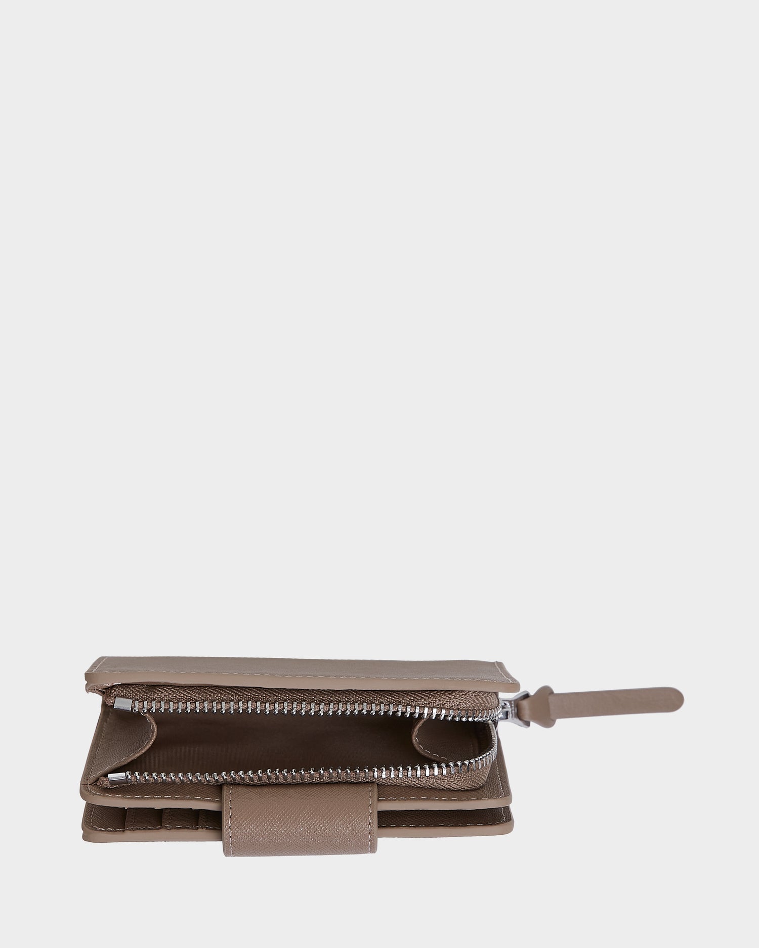 The NOVALIE - L424500 Sand by Rudsak is a brown leather wallet featuring a partially open zipper compartment, revealing its interior. This compact accessory is displayed against a plain white background.