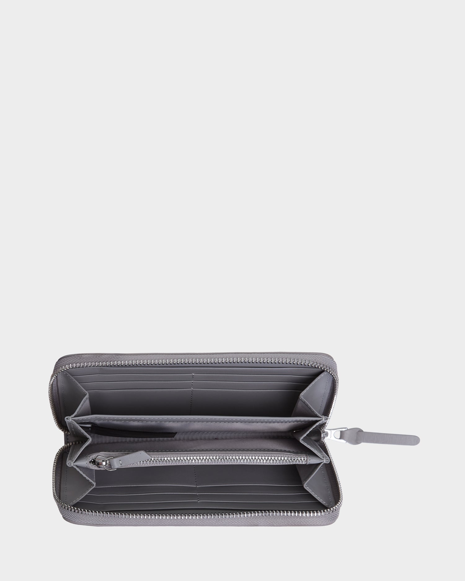 A close-up of the Rudsak NYLA - L424502 Grey womens leather wallet, showcasing its cardholder slots and secure zippered compartment.