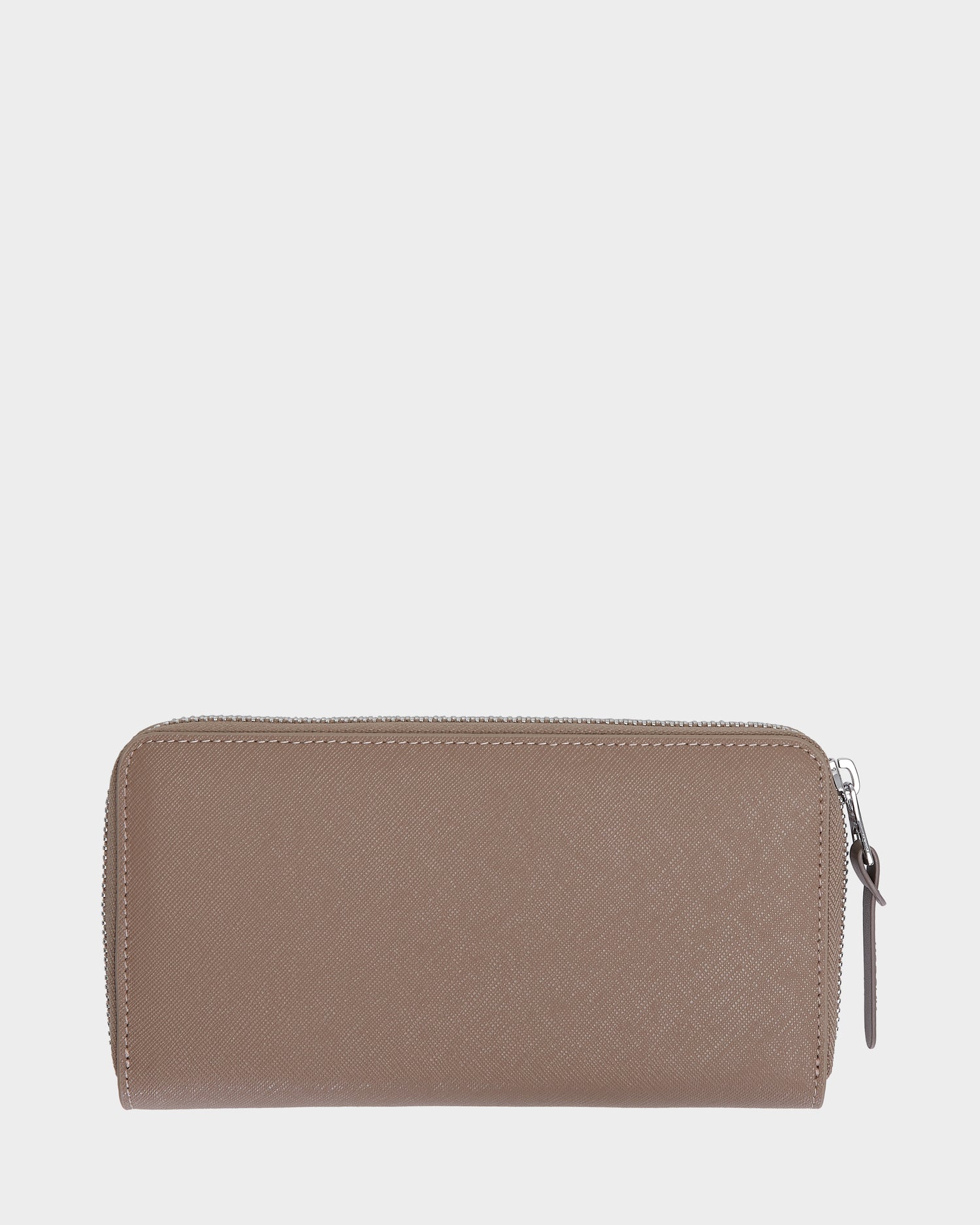The Rudsak NYLA - L424502 Sand is a taupe womens leather wallet with a textured finish, rectangular shape, and zippered compartment. Photographed on a plain light gray background, it features organized card slots inside and a visible zipper pull on the right.