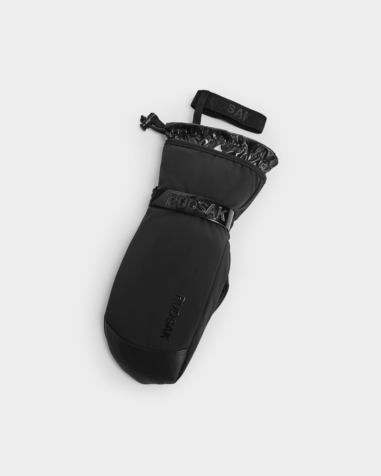 The Rudsak OLTEN - 8424513 black insulated winter mitten features a glossy wrist trim, adjustable strap, and embossed branding on the wrist. These stylish ski mittens are shown against a plain white background.