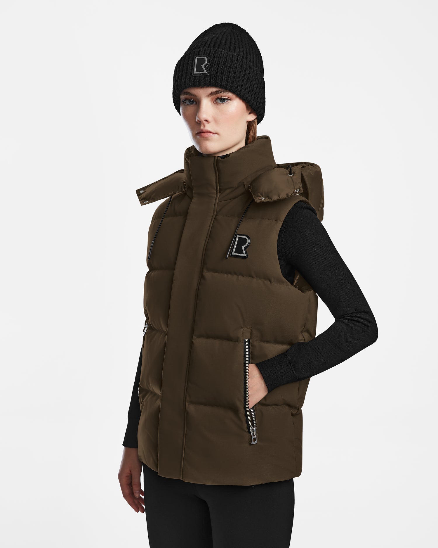 A woman wearing the Rudsak REN M - 9123512 Army W weather-resistant puffer vest.