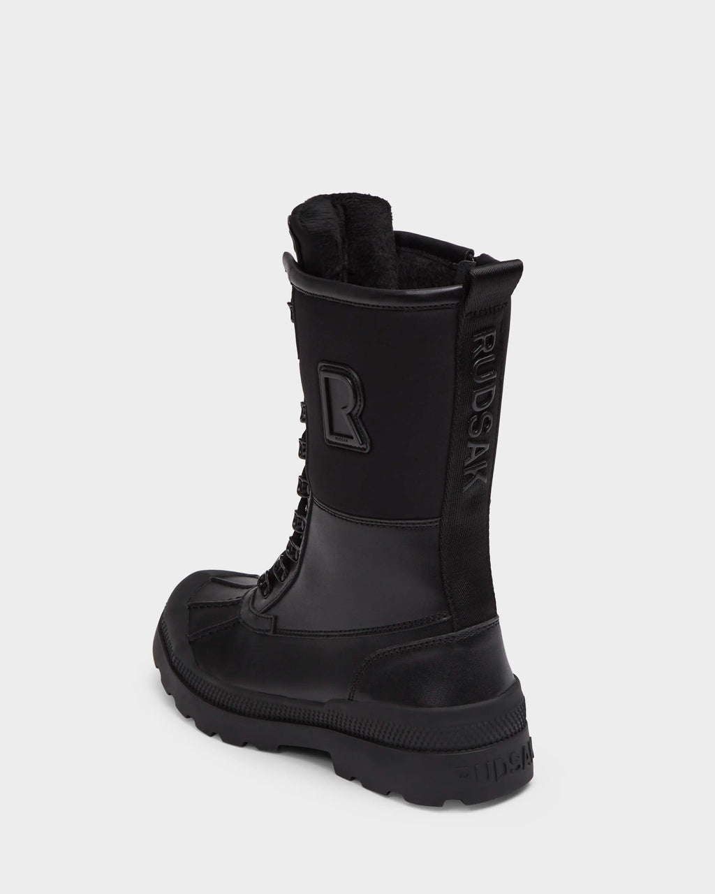 The Rudsak RITA - L222502 Black is a women’s black high-top winter boot with weather-treated leather, thick rubber sole, visible laces, and embossed branding on the side and back heel, displayed on a plain white background.